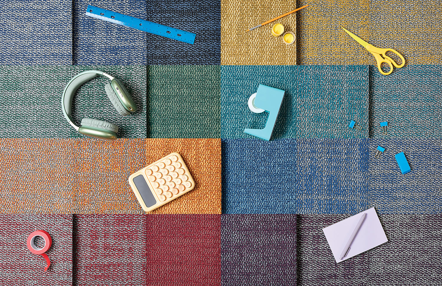 A colorful rug with various items on it.