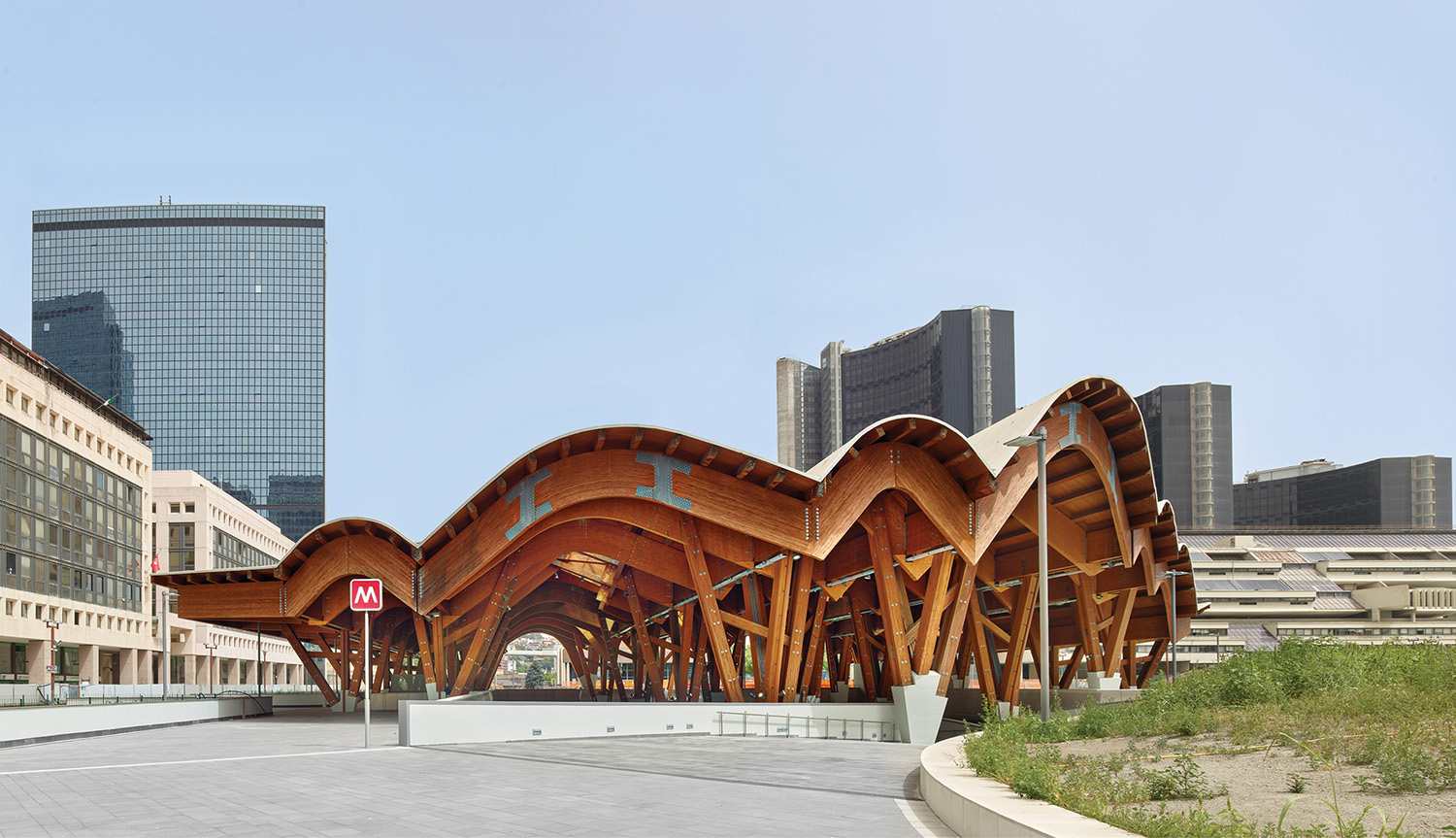 A large wooden structure in a city square.