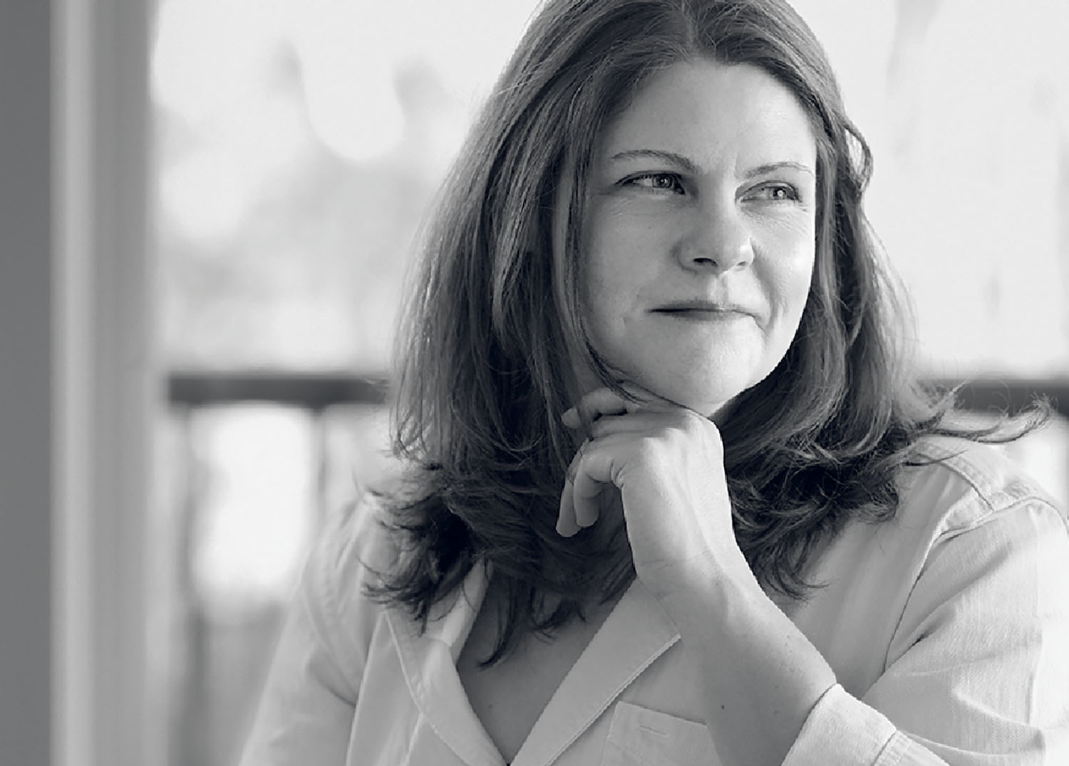 A woman in a white shirt looking at the camera.