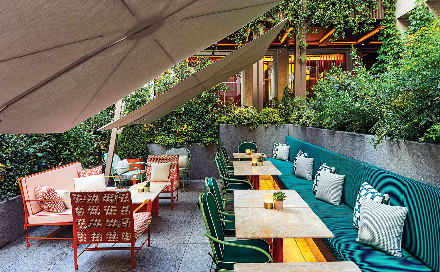 A patio with a table and chairs under an umbrella.
