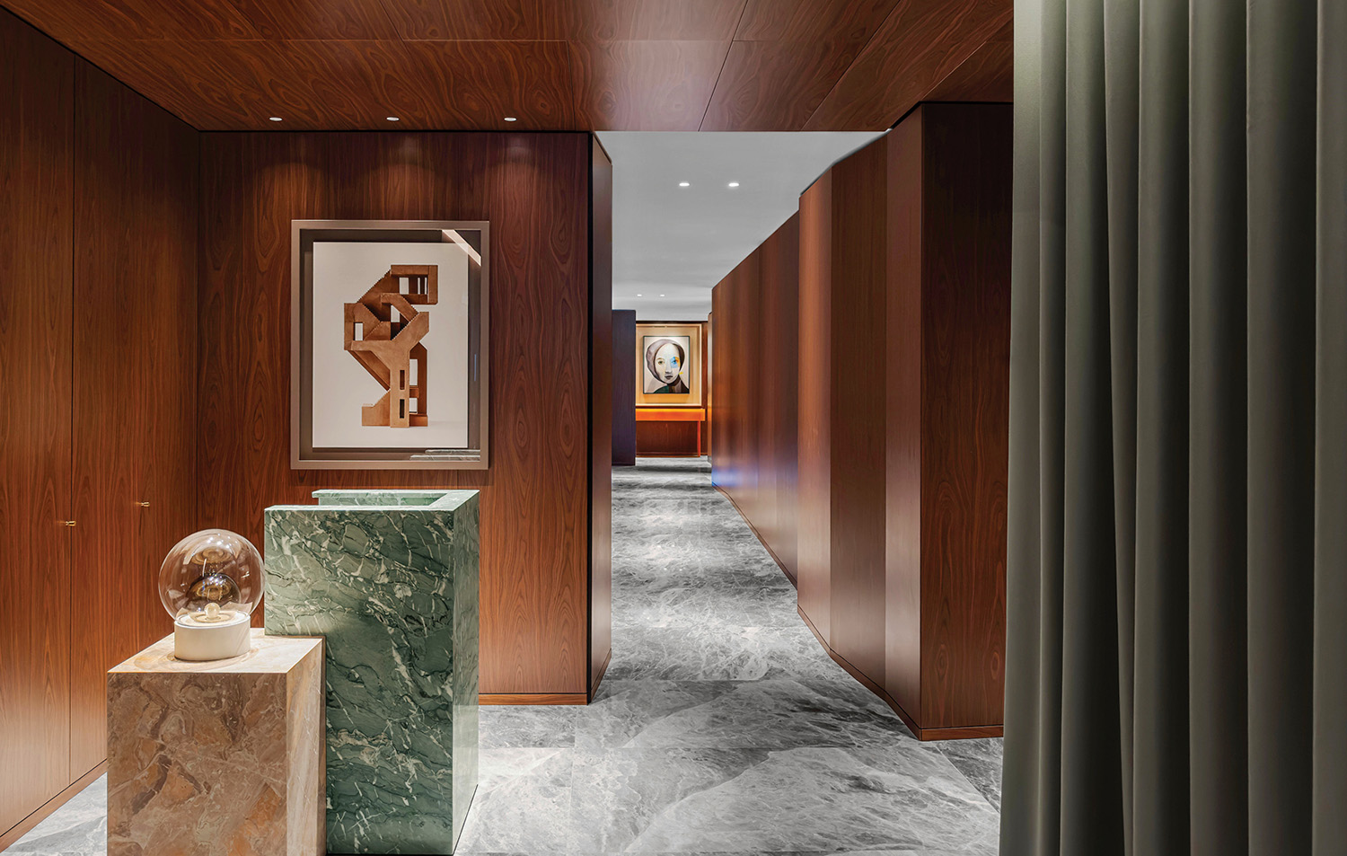 A hallway with a marble floor and a marble vase.