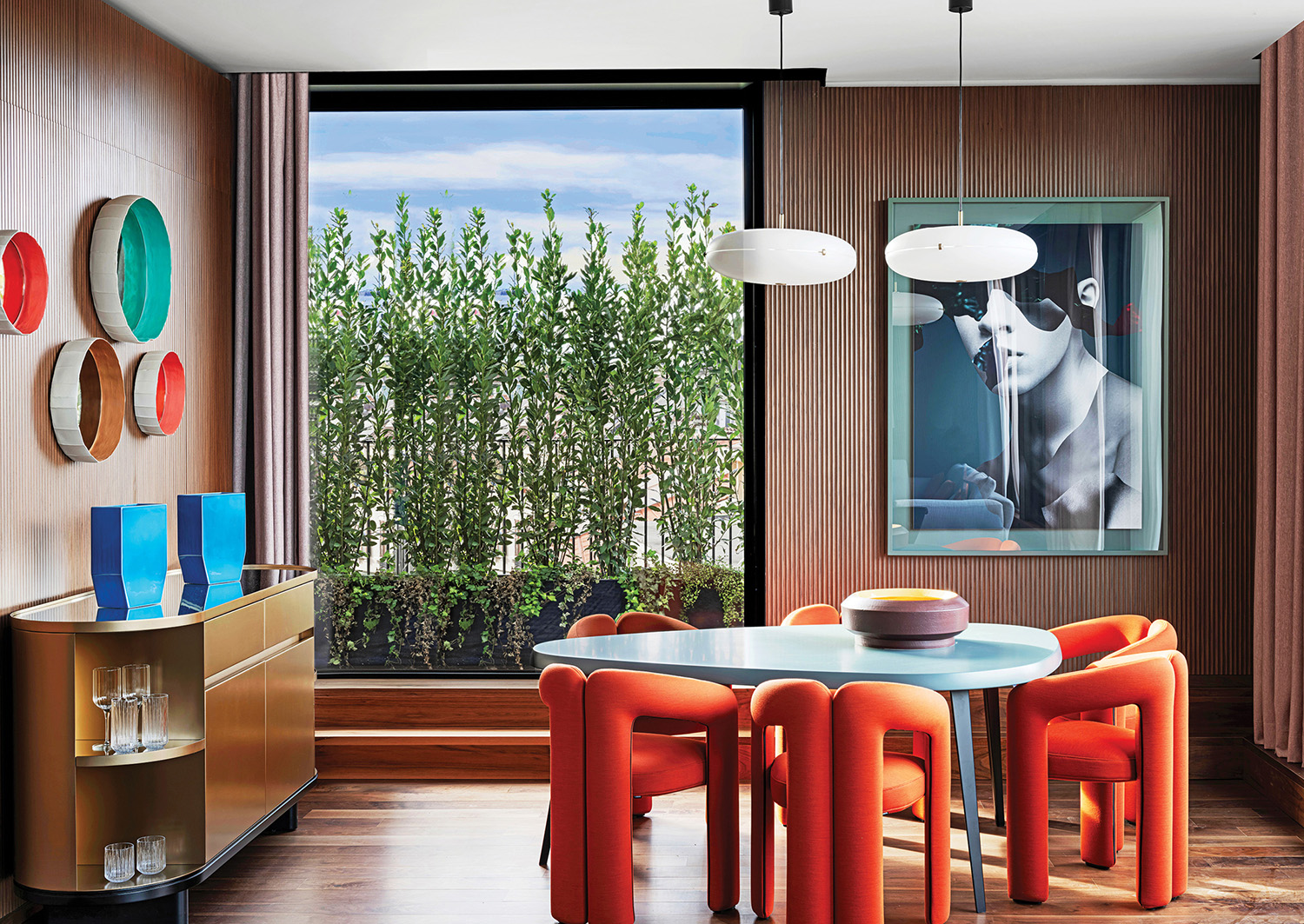 A dining room with a table and chairs.