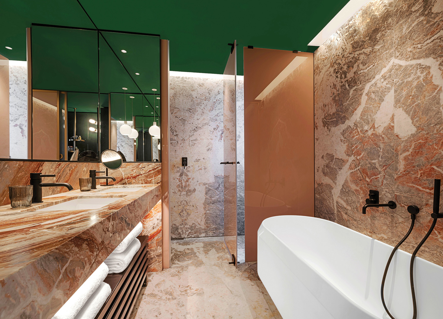 A bathroom with a marble wall and a bathtub.