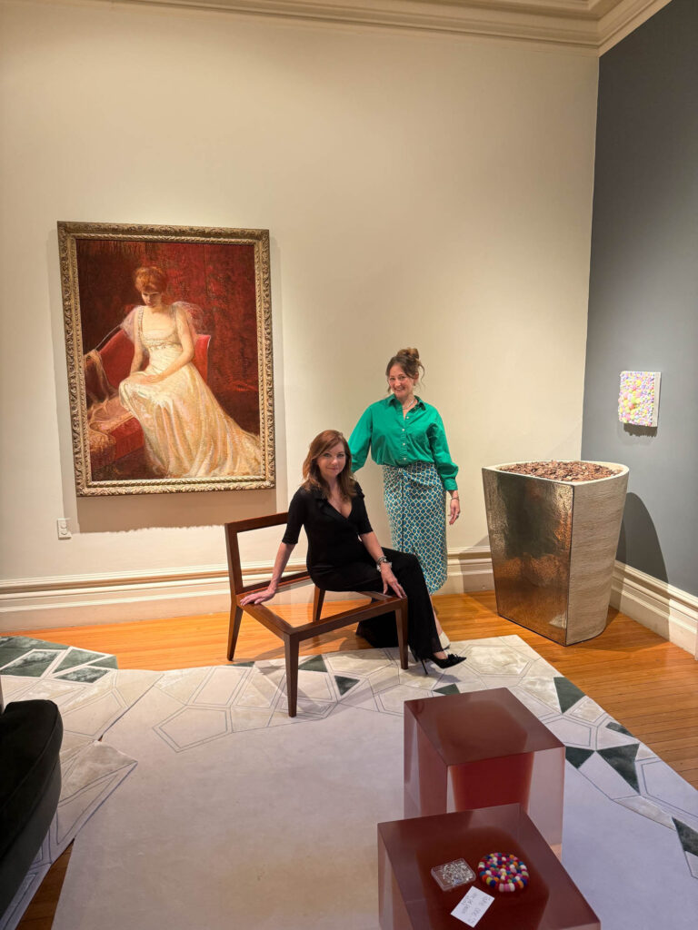 lauren rottet on a chair in her exhibit room