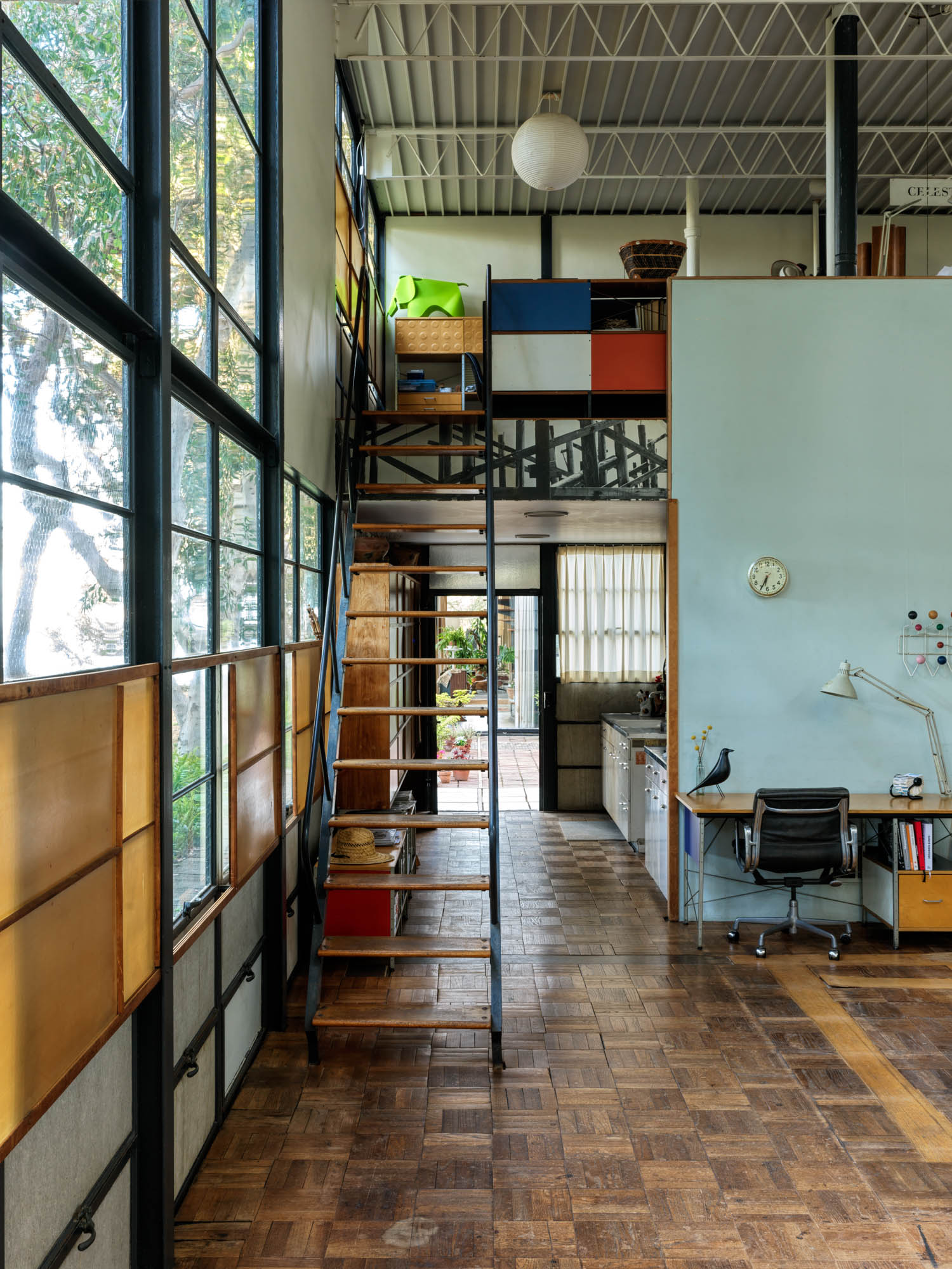 studio space with long ladder like stairs to the loft