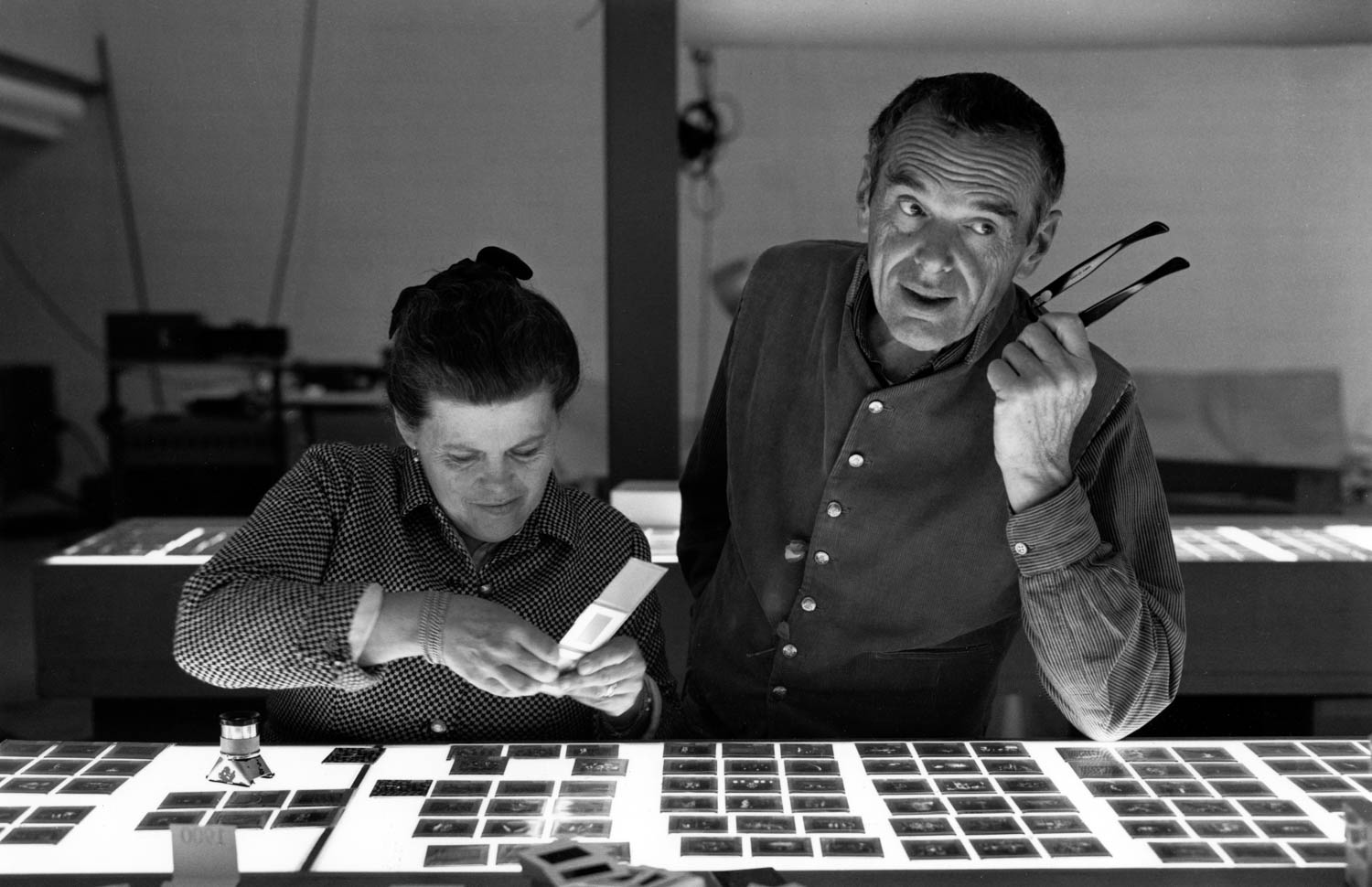 two people sorting through photographic slides