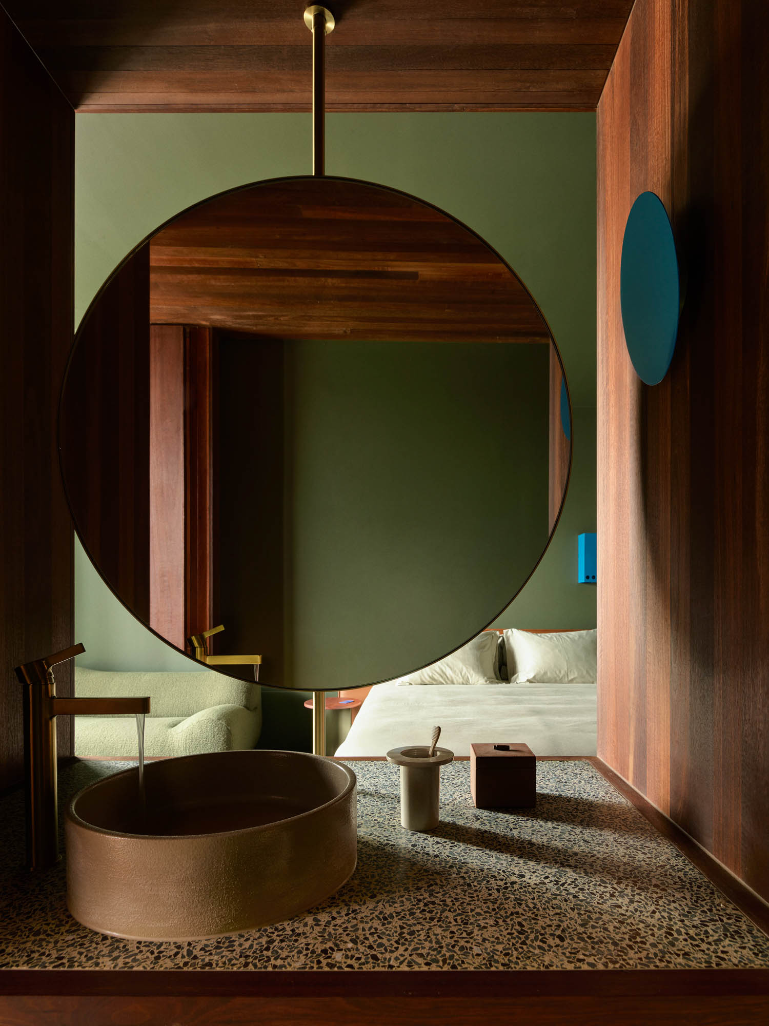 green room with circular mirror