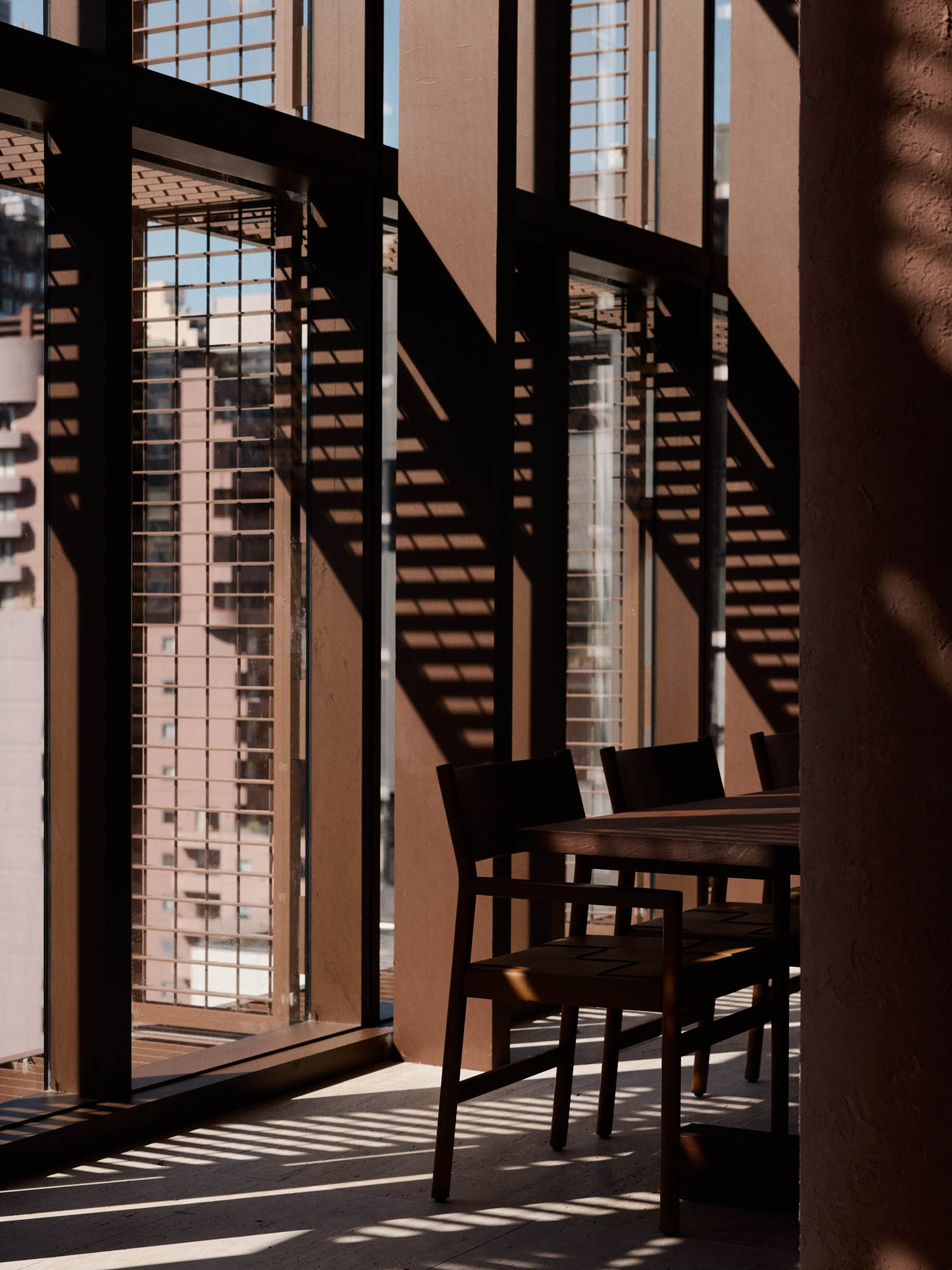 chairs in the shadow on the side of the room