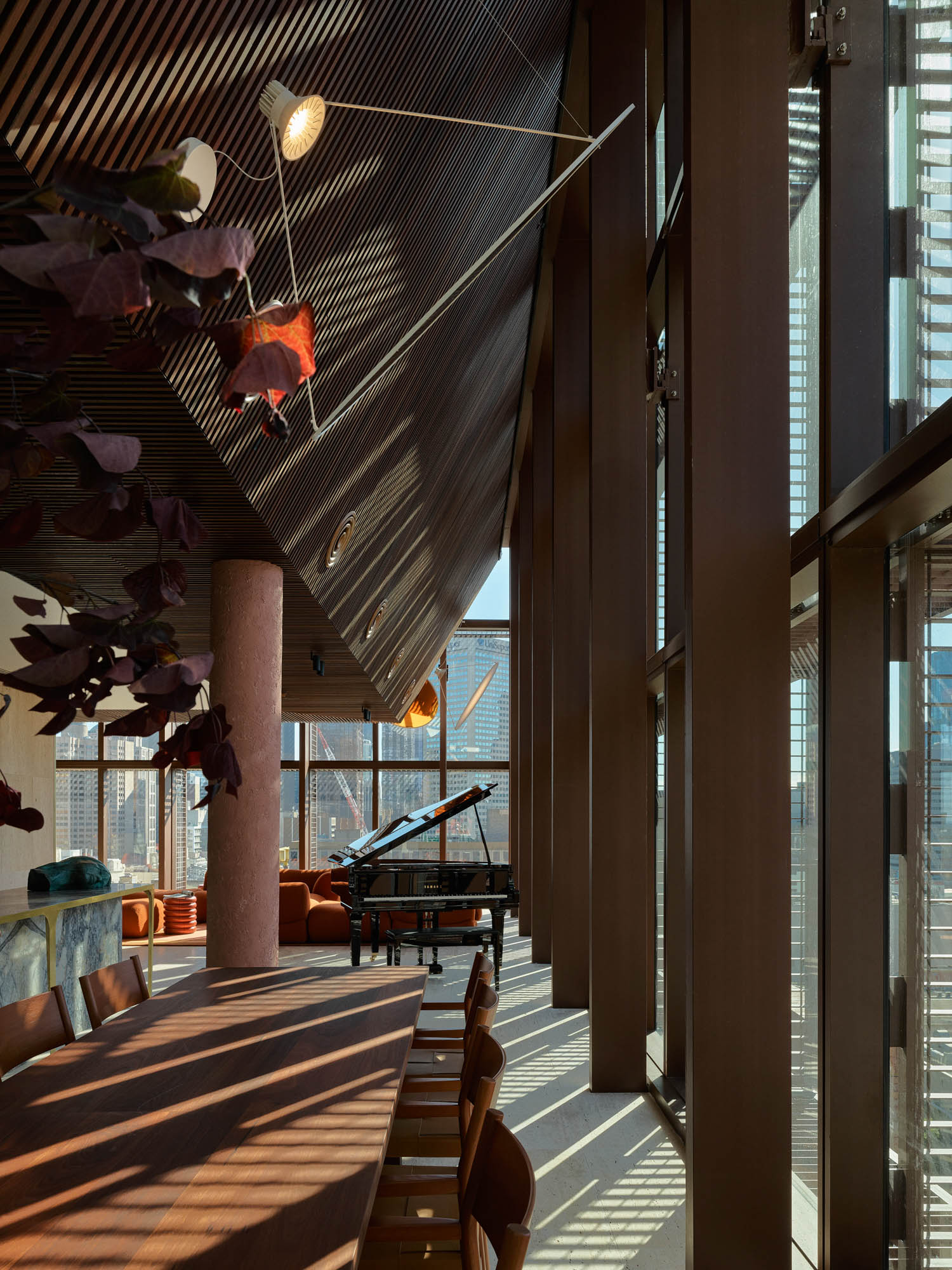 penthouse with lots of chairs and a piano