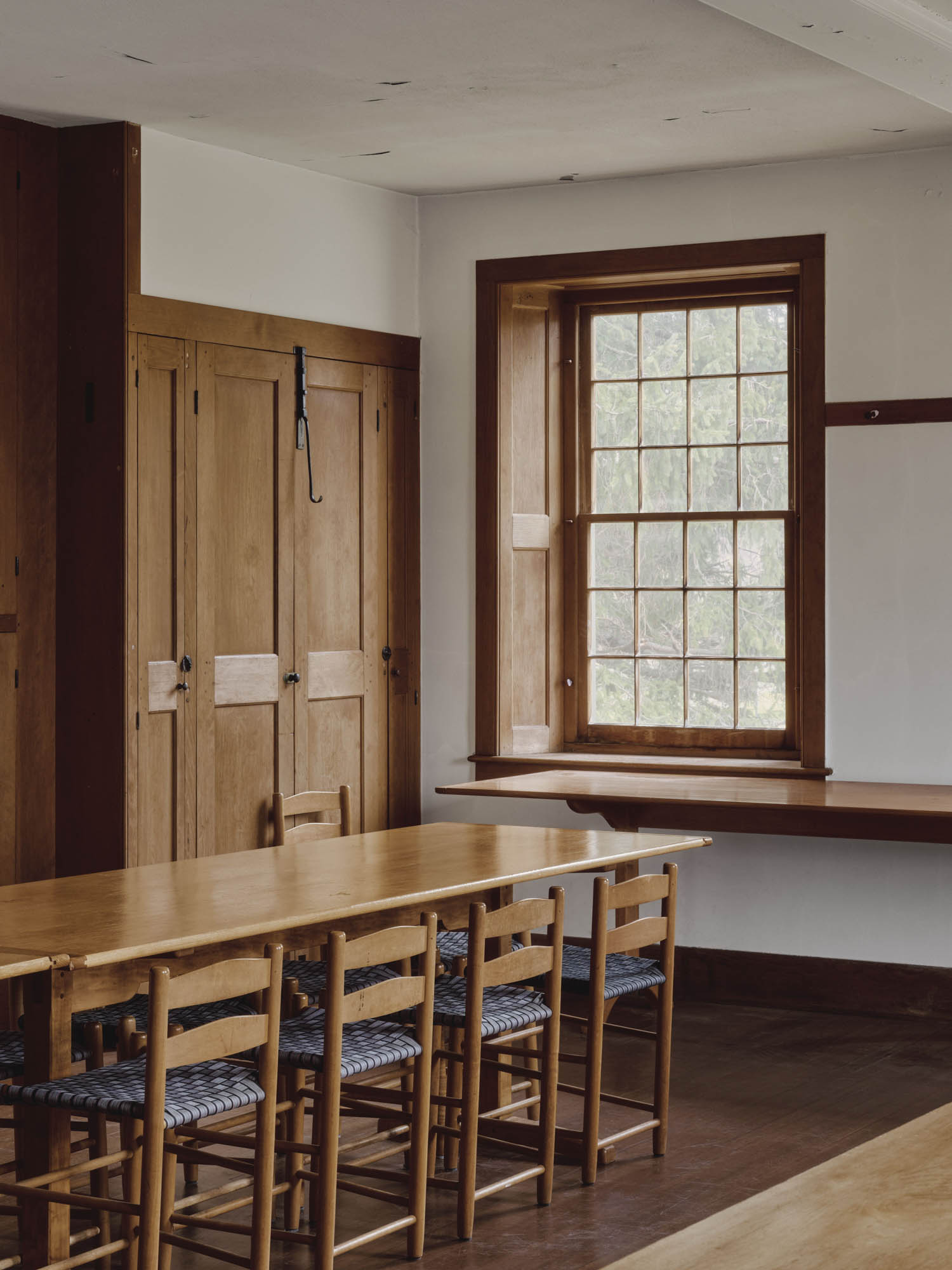 room with long table and wooden wardrobe