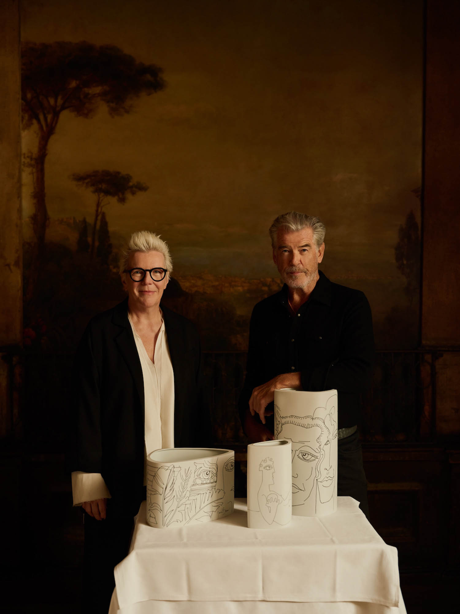 Pierce Brosnan and Stefanie Hering standing next to new collection