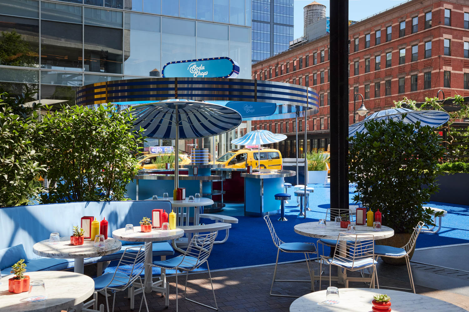 seating area outside with lots of blue chairs and booths