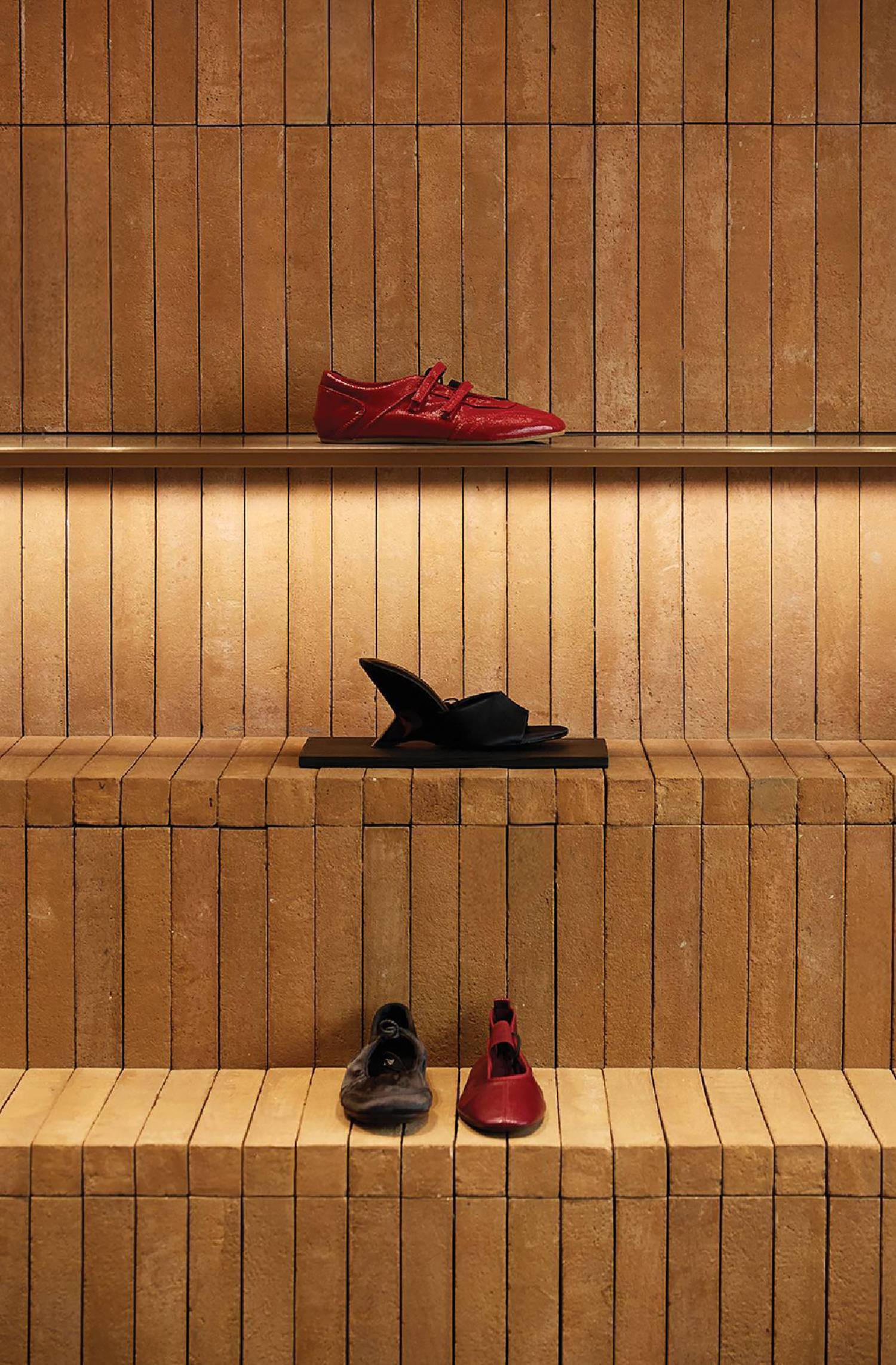 A row of shoes on a shelf in a store