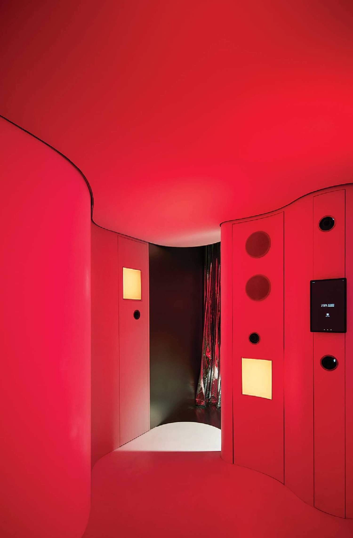 A red room with a mirror and a red wall