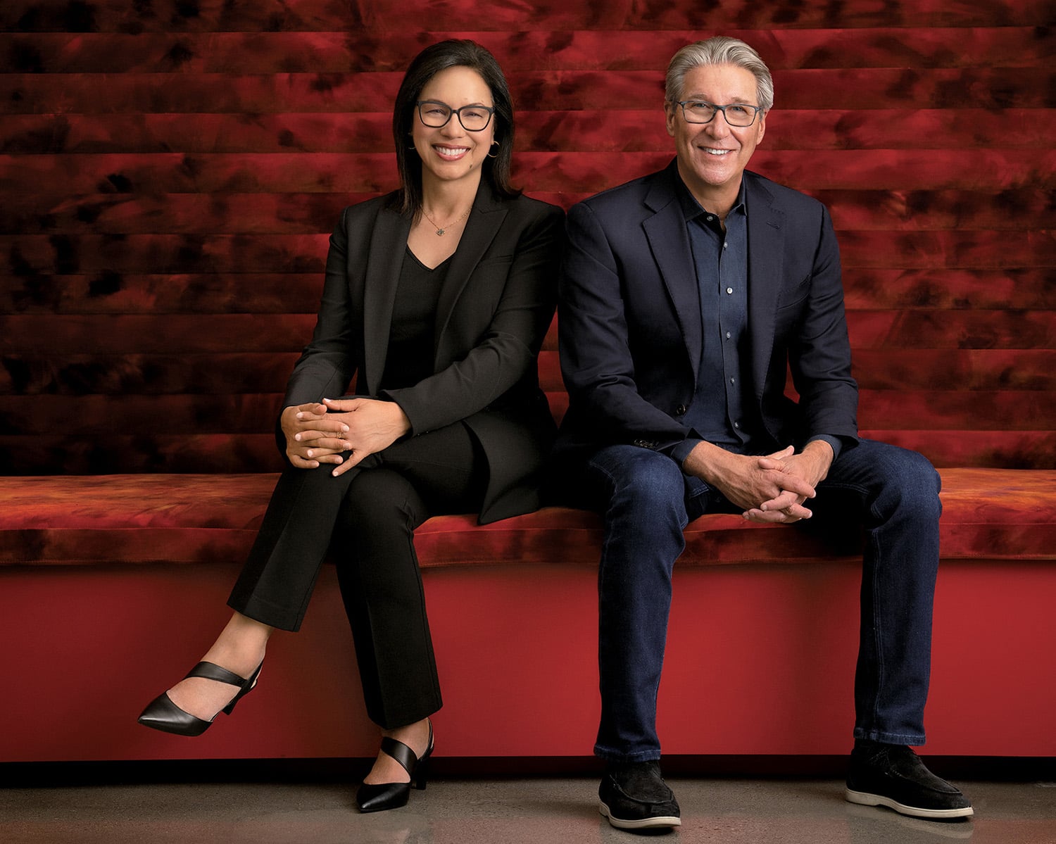 Gensler global cochairs sitting on red bench