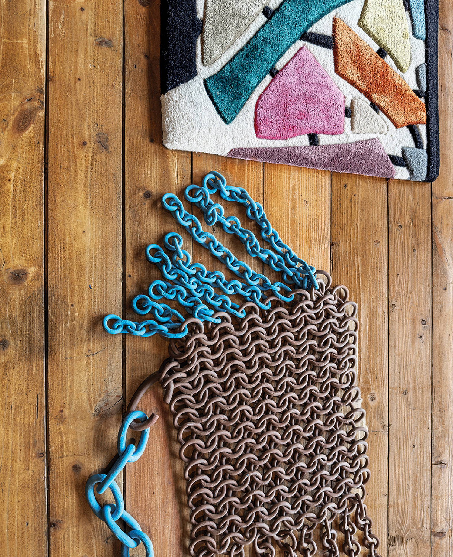 A rug and a chain on a wooden floor