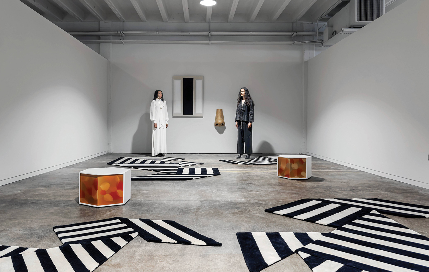 A woman standing in a room with a black and white rug