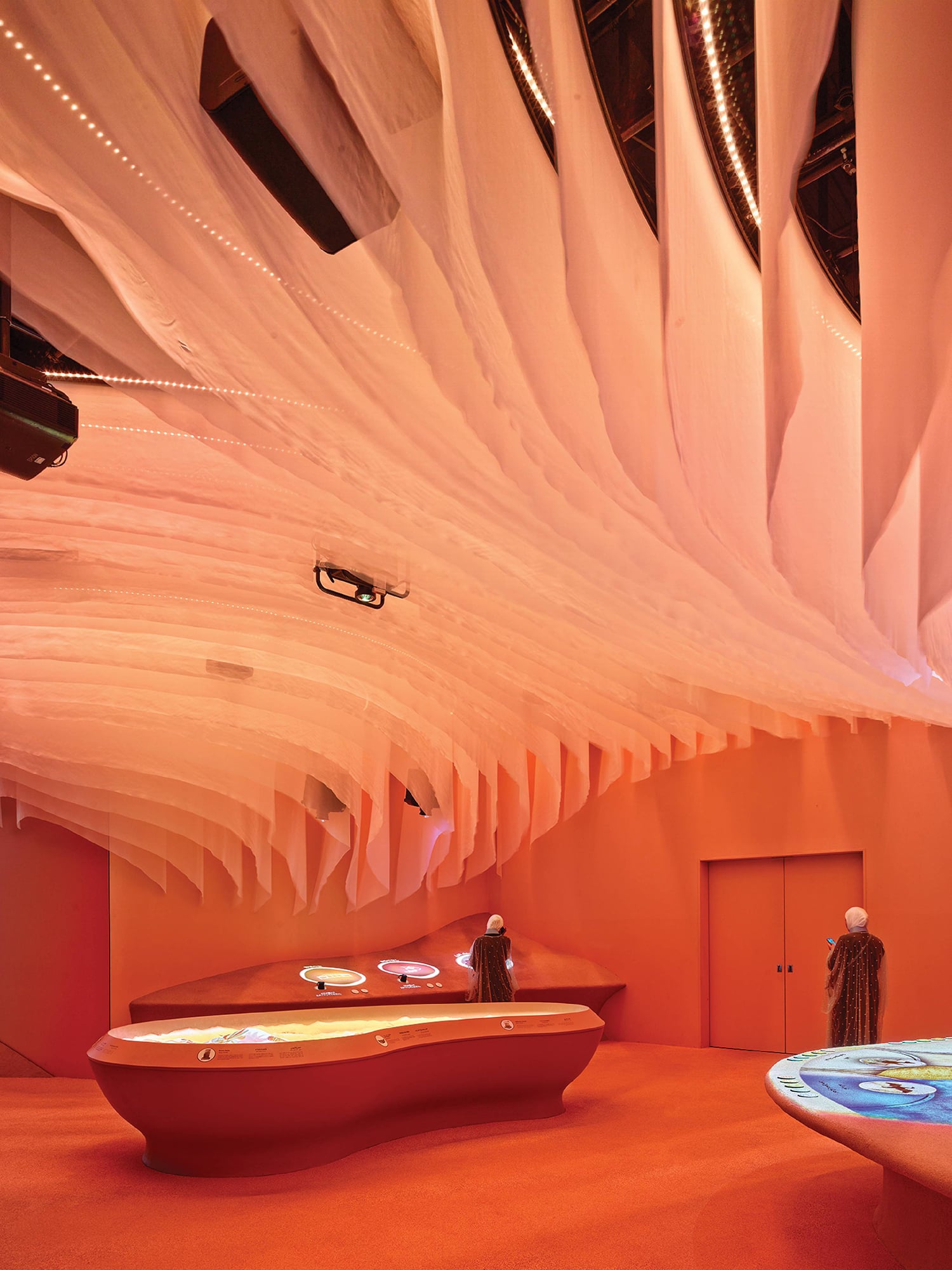 A room with a large white curtain hanging from the ceiling