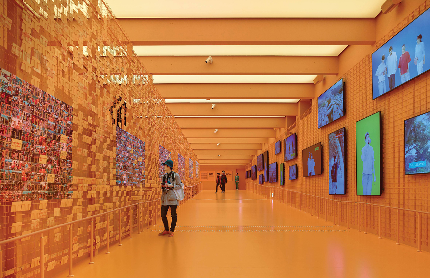 A long hallway with multiple pictures on the walls