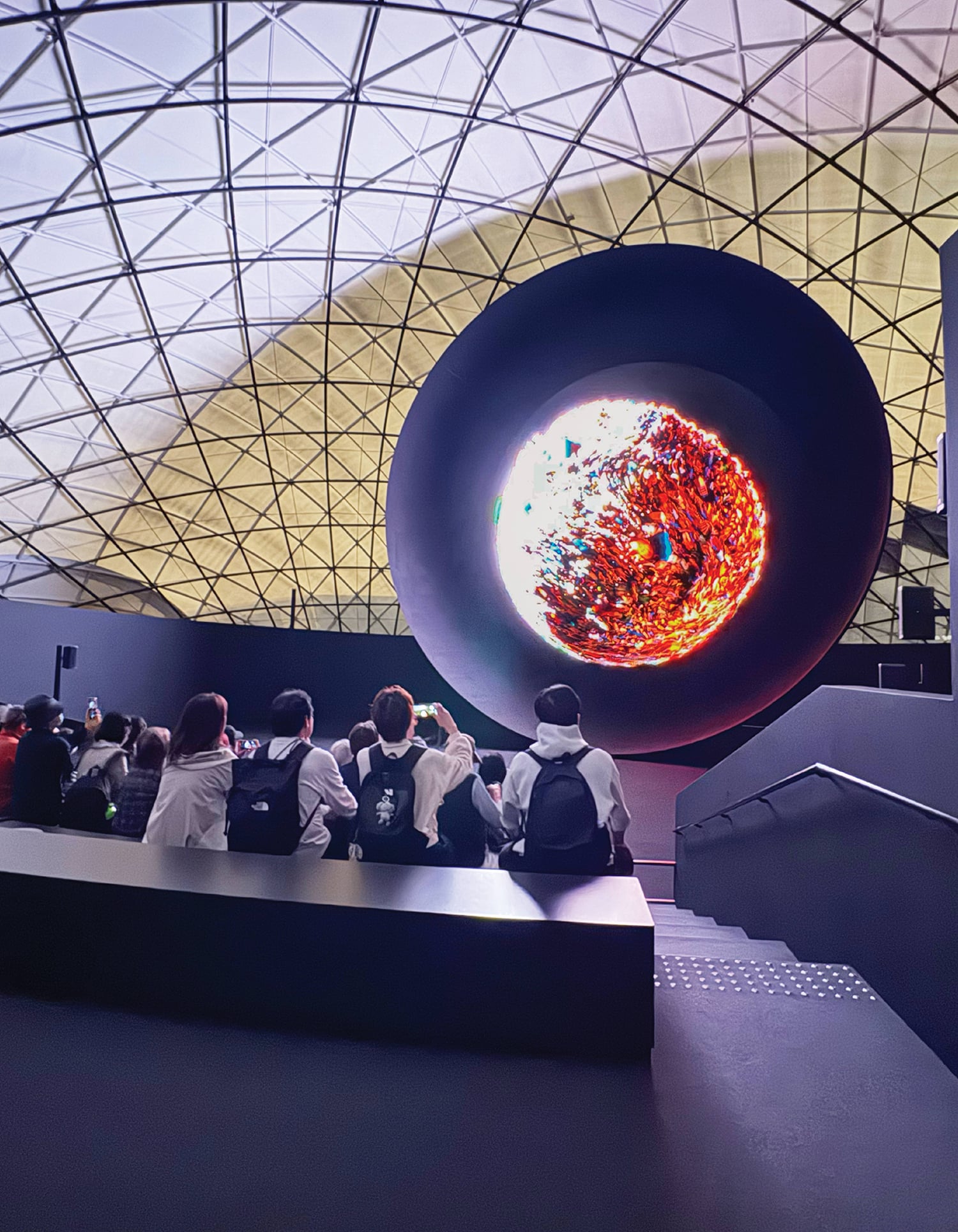 A group of people sitting on a bench in a building