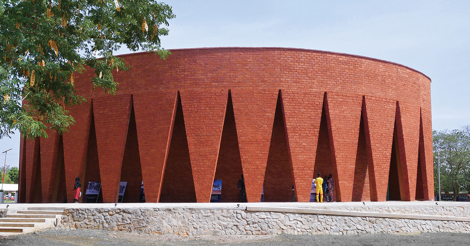A large brick building with a tree in front of it