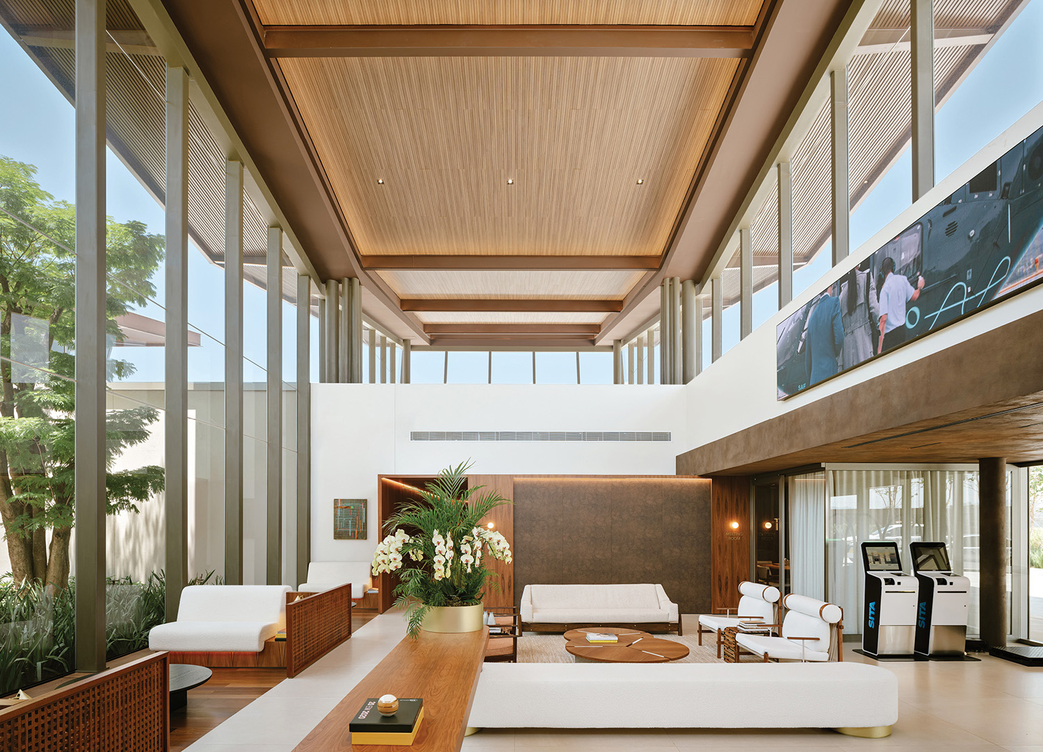 A living room with a large screen on the wall