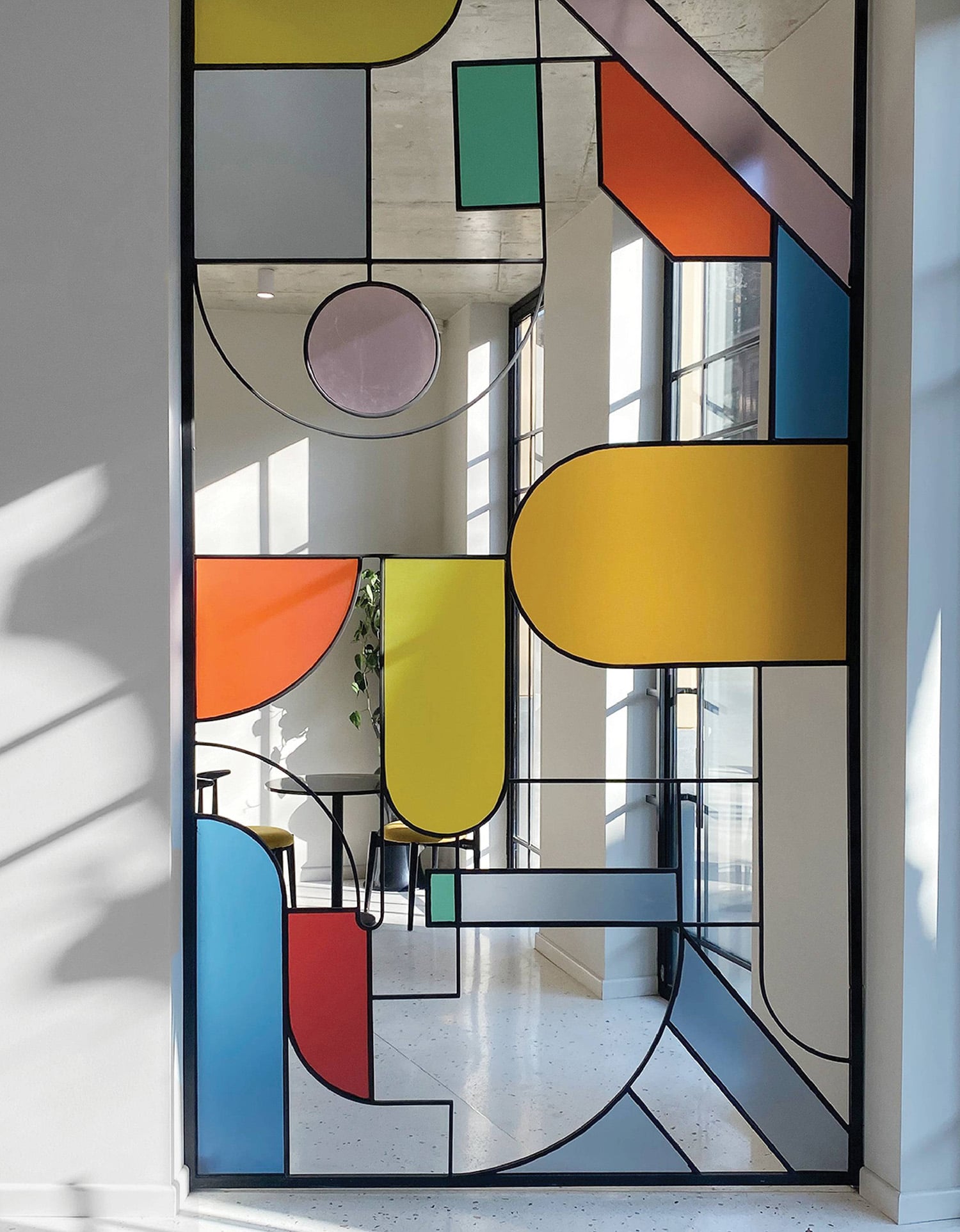 A large glass window with colorful shapes