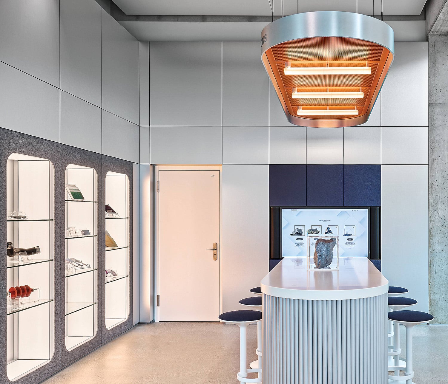 A kitchen with a white counter and a blue stool