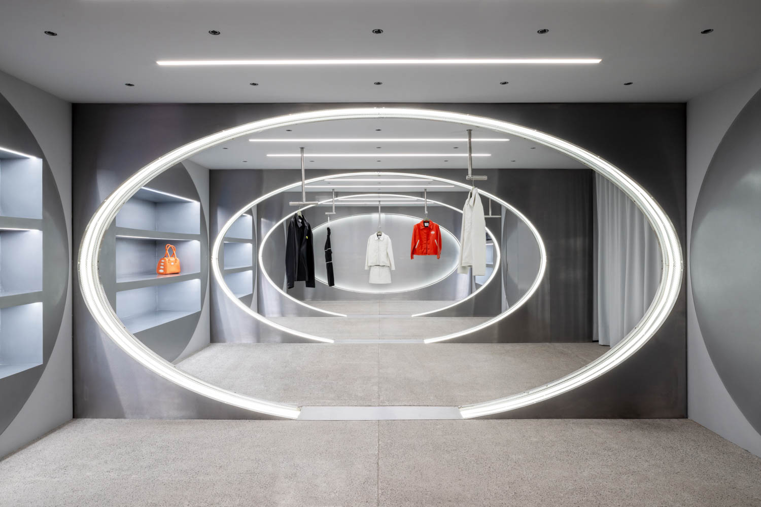 view of multiple shelves with clothing