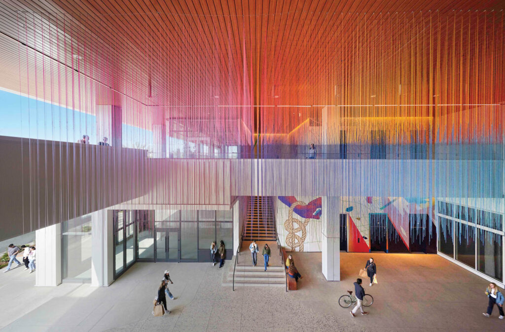multiple people walking around inside a building