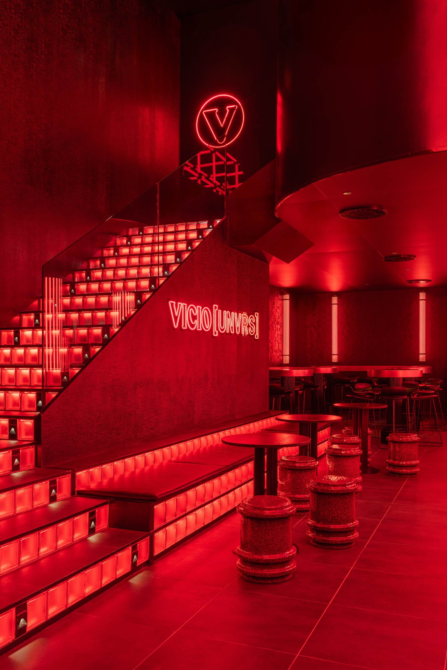 bright red lighting inside a lounge area with seating