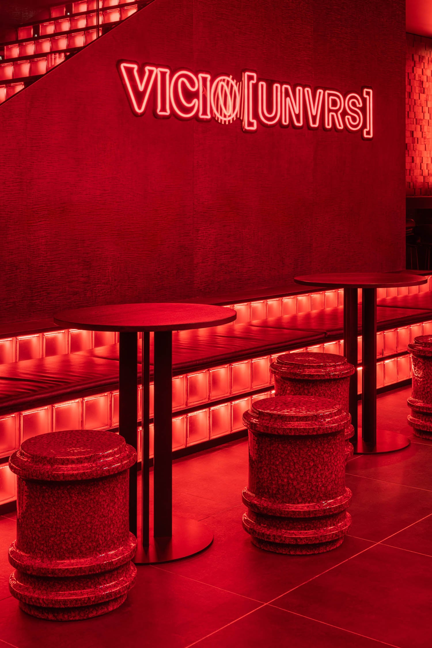 bright red lighting inside a lounge area with seating