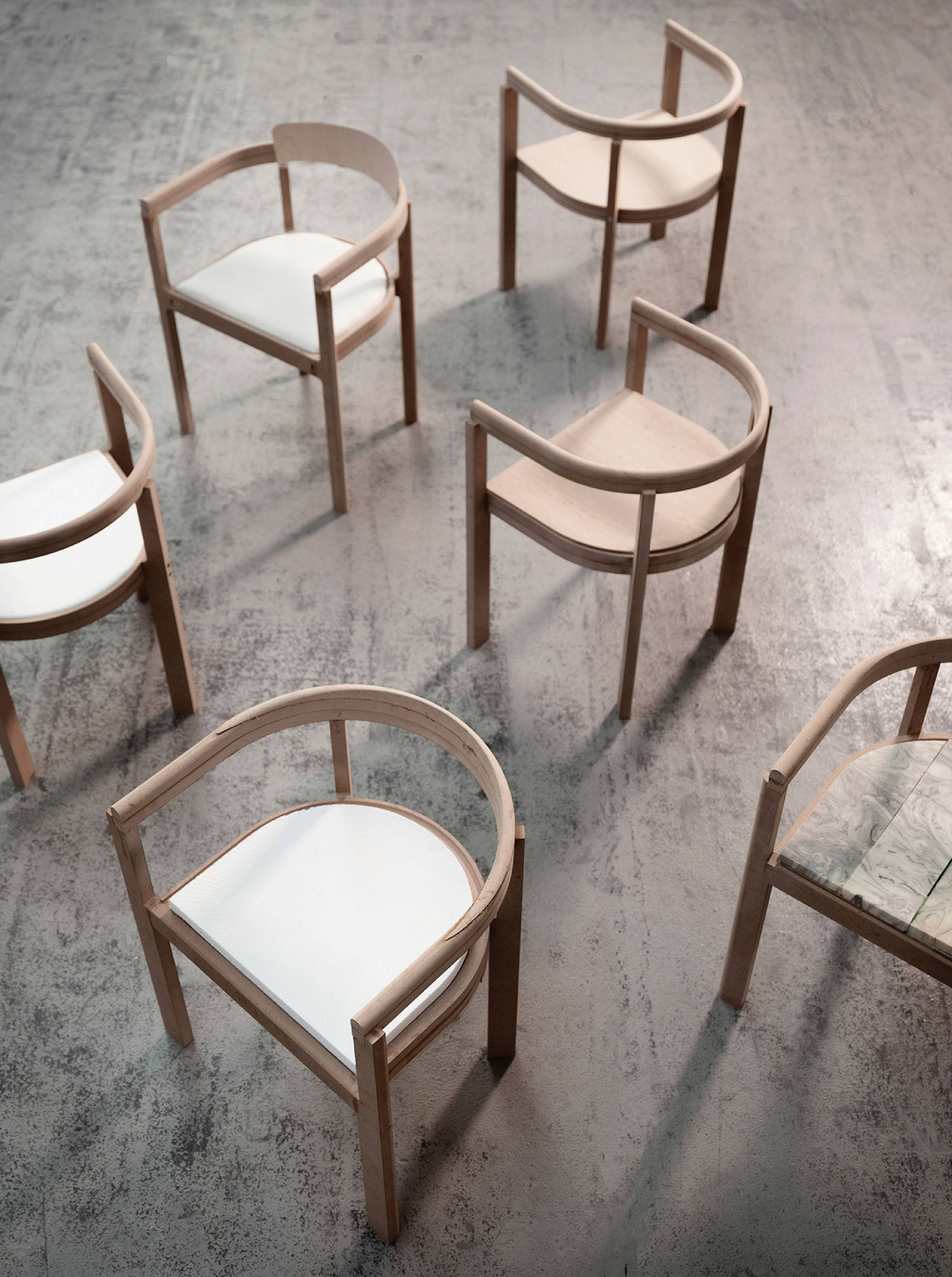 A group of chairs sitting on top of a cement floor.