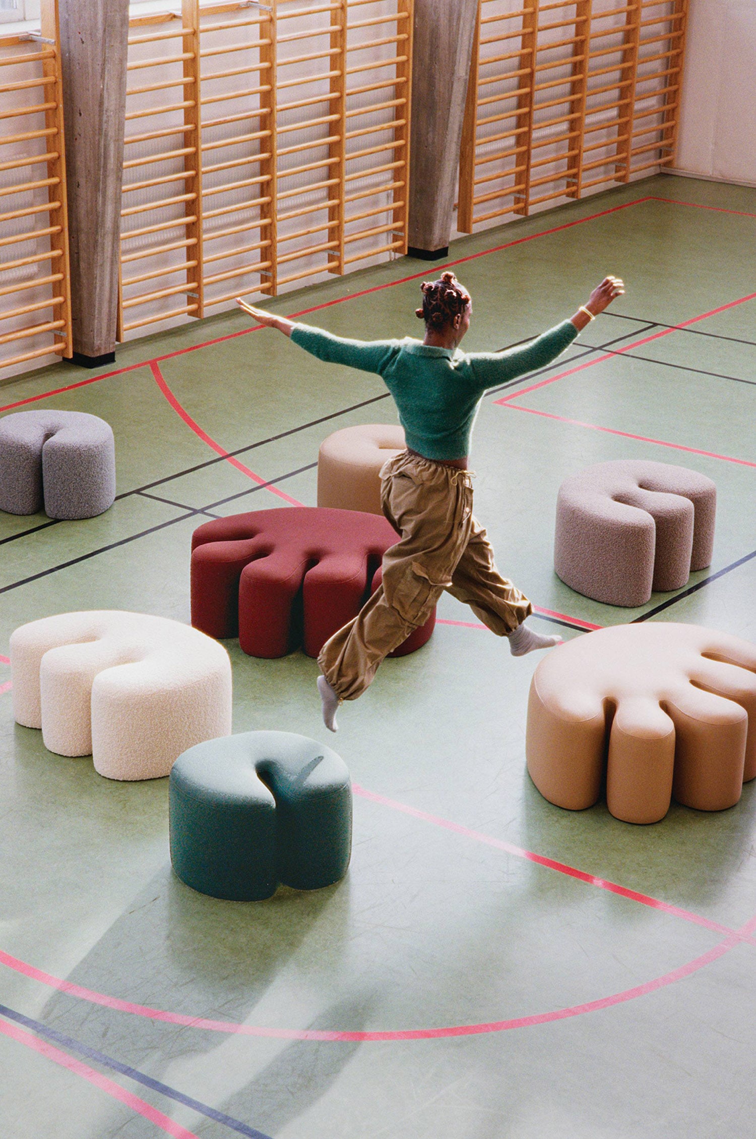 A man jumping in the air with a bunch of pillows.