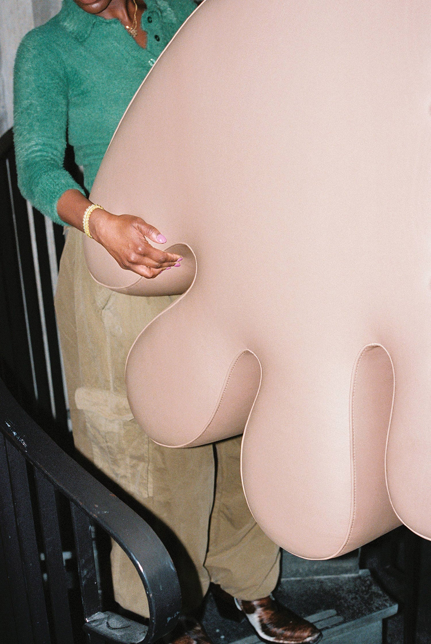 A man holding a giant stuffed elephant.