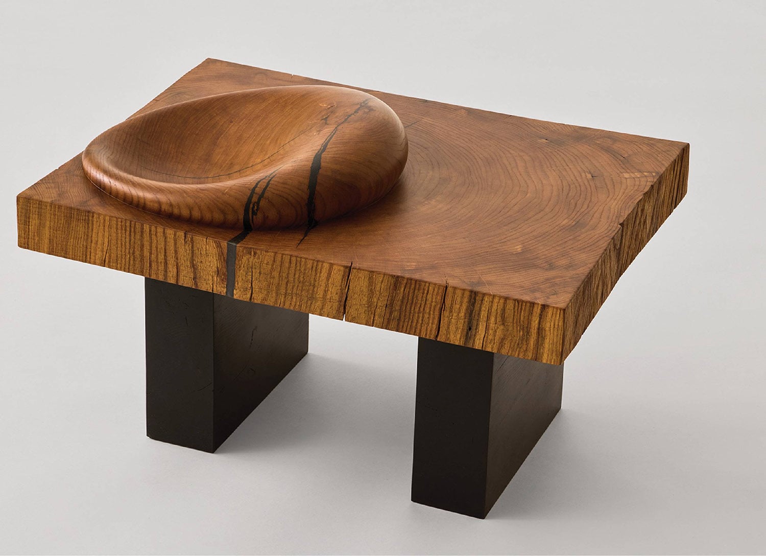 A wooden table with a bowl on top.