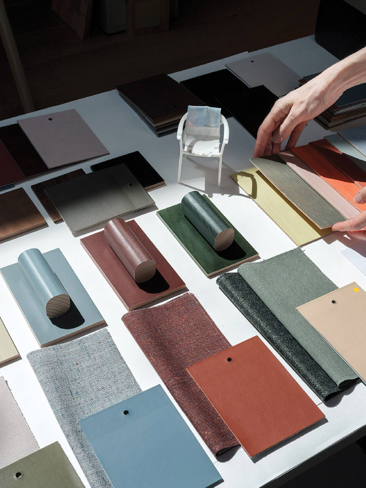 A person is putting a piece of paper on a table.