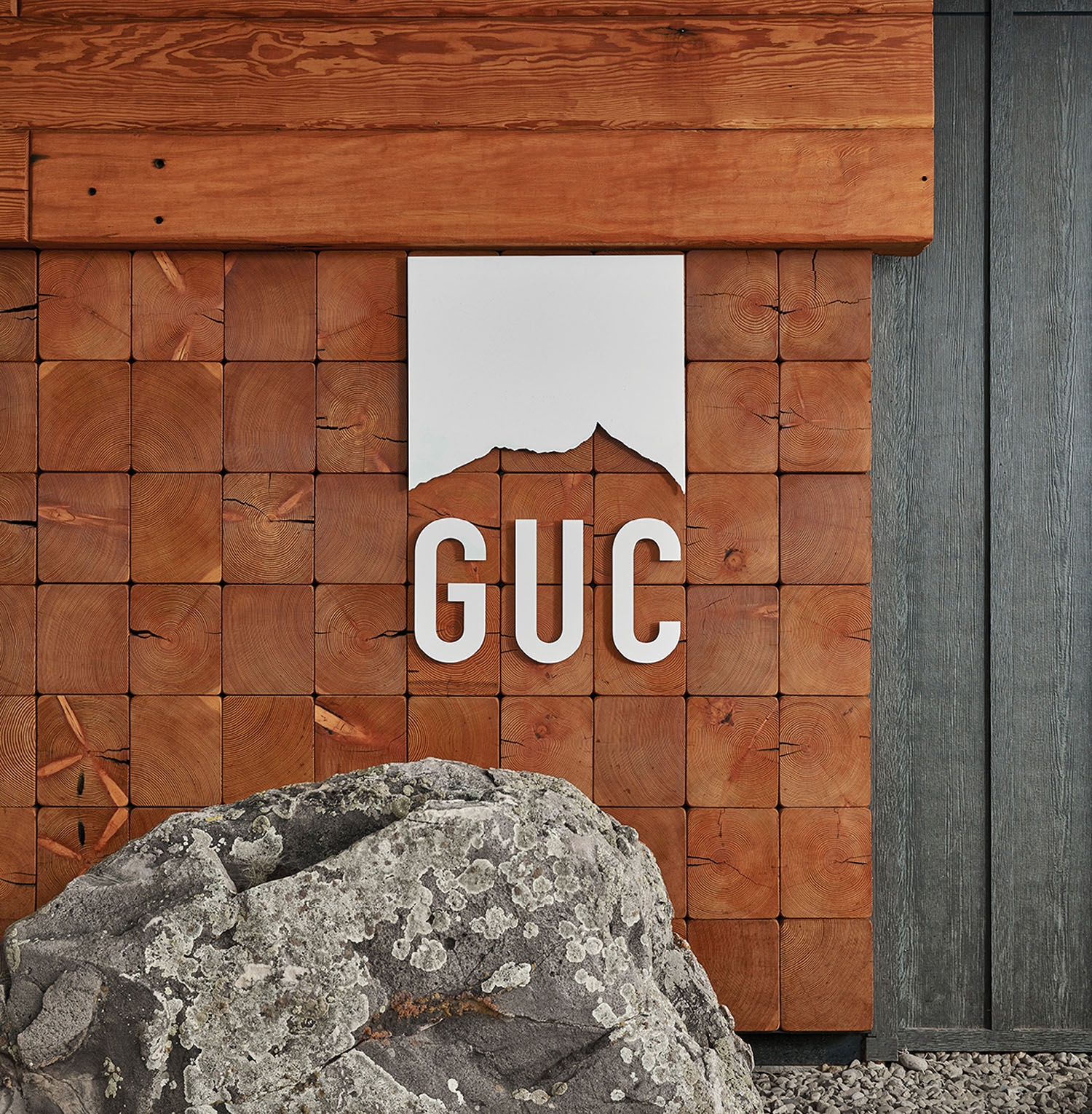 A large rock in front of a building