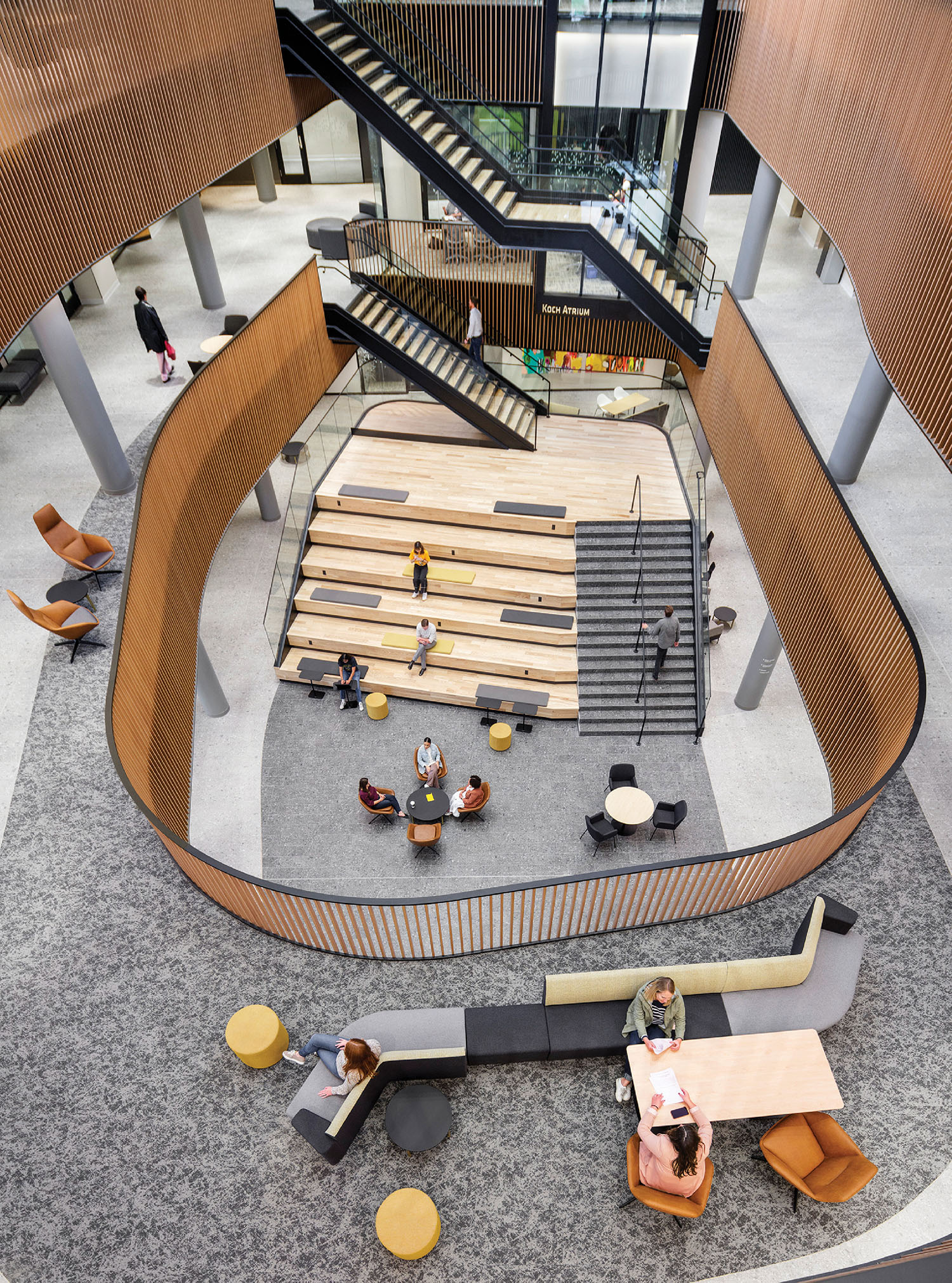 A group of people sitting on benches in a building