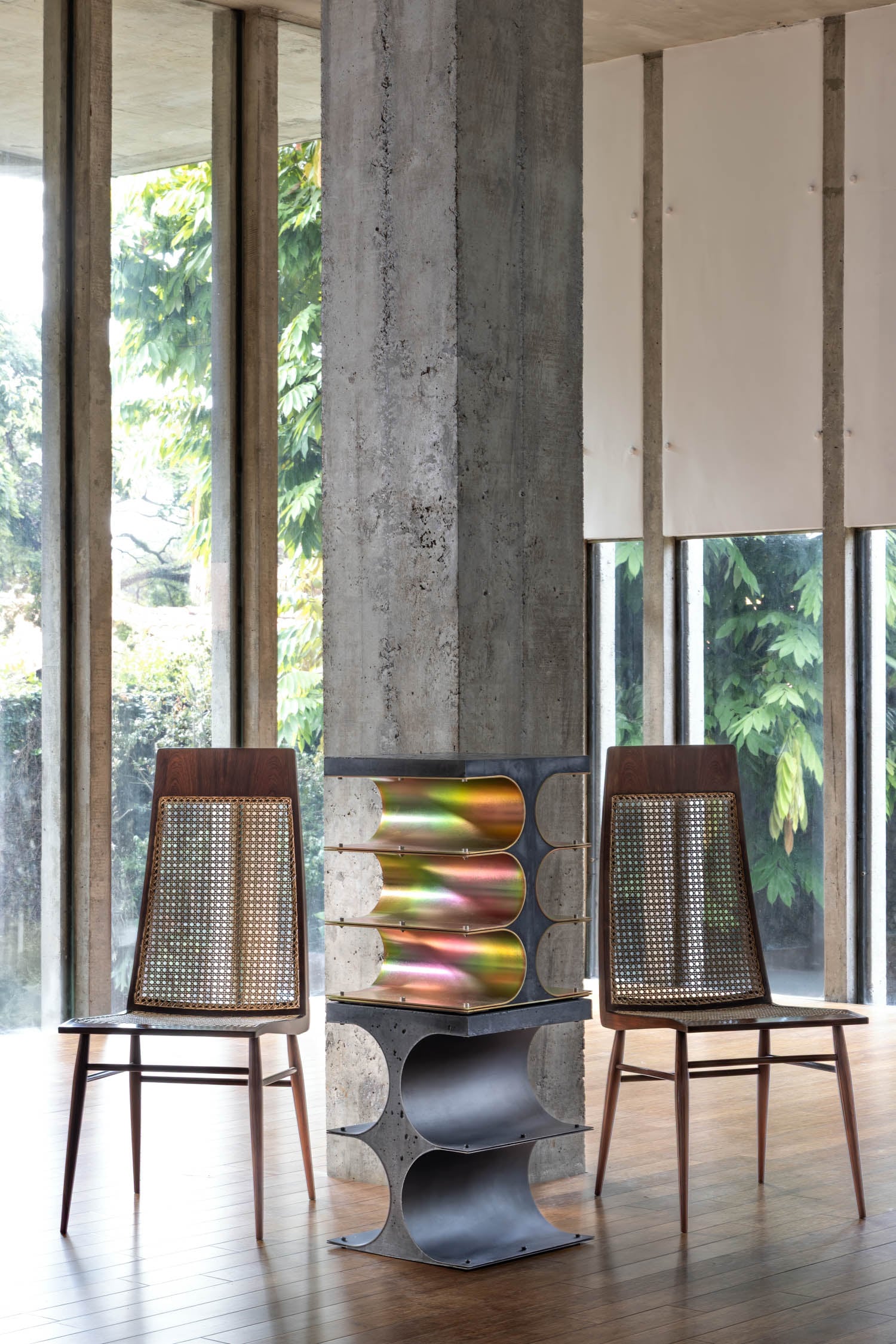 two chairs next to art piece