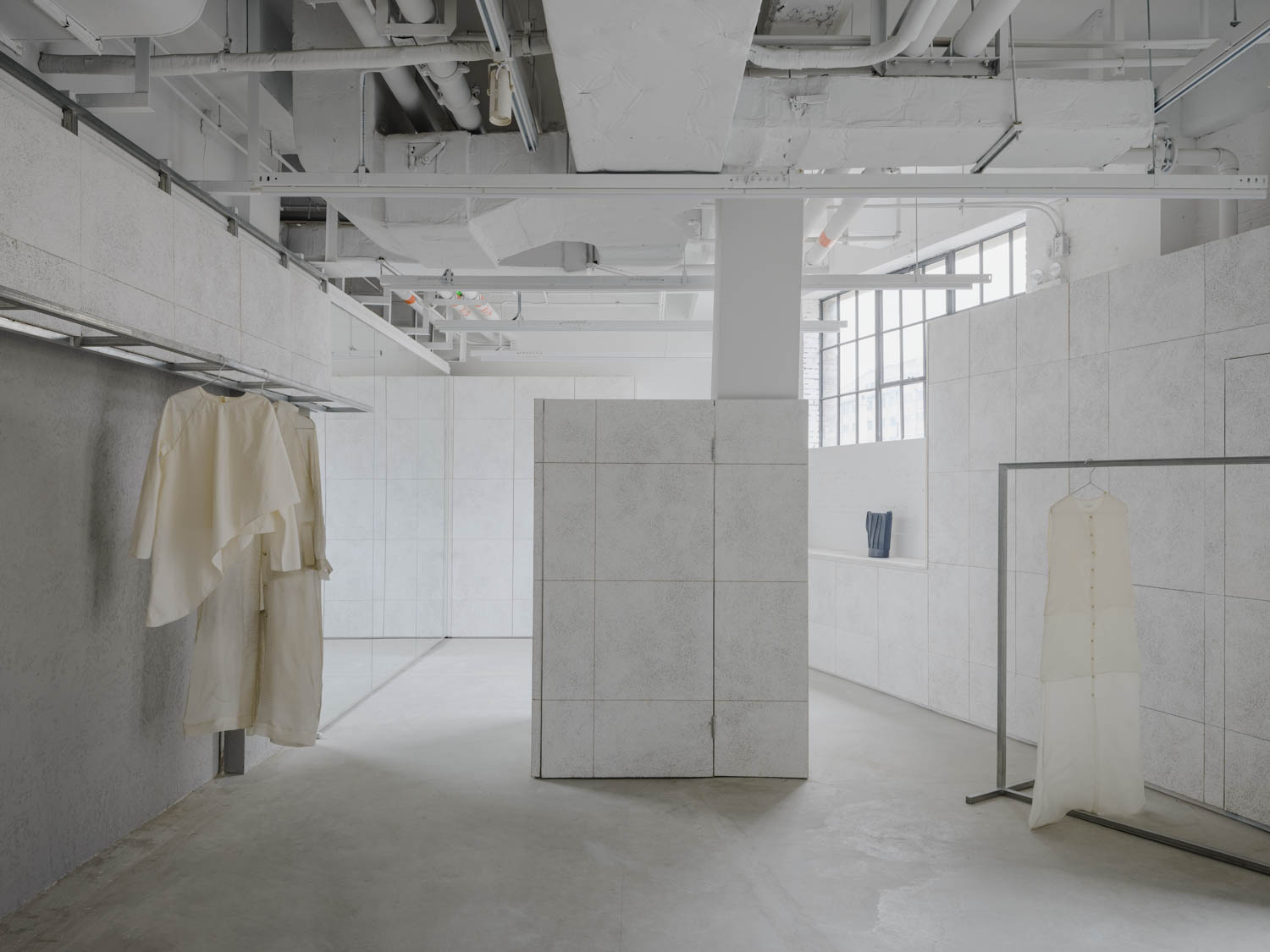white showroom area with clothes