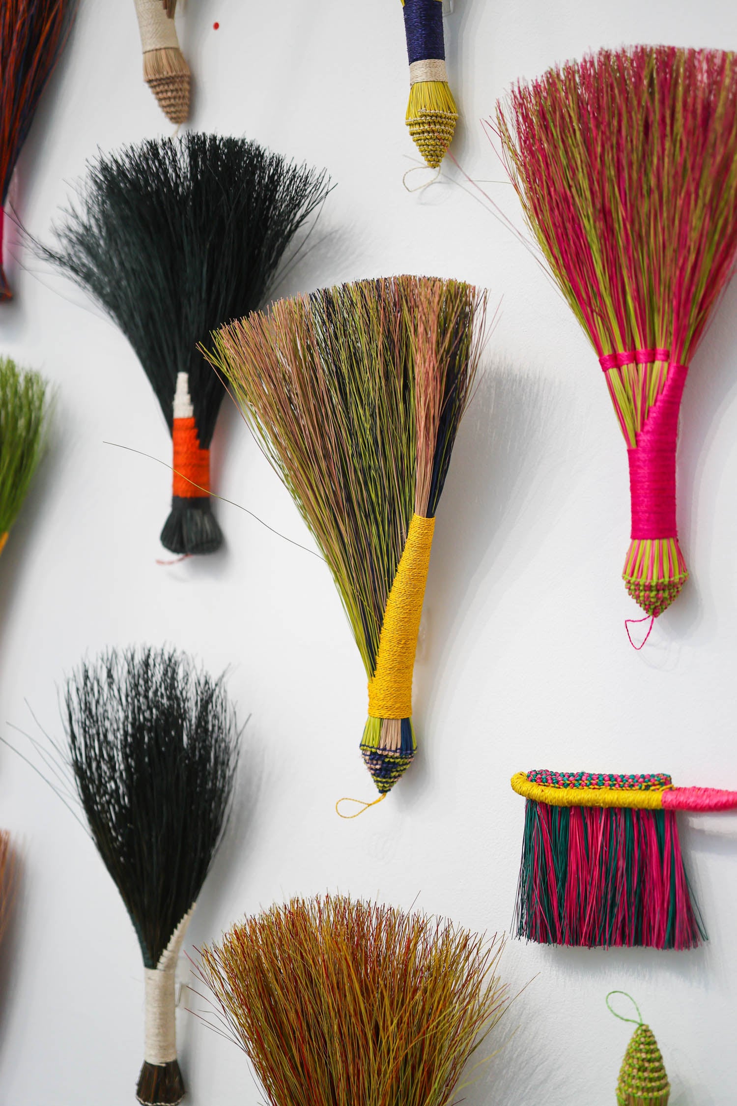 multiple brooms next to each other