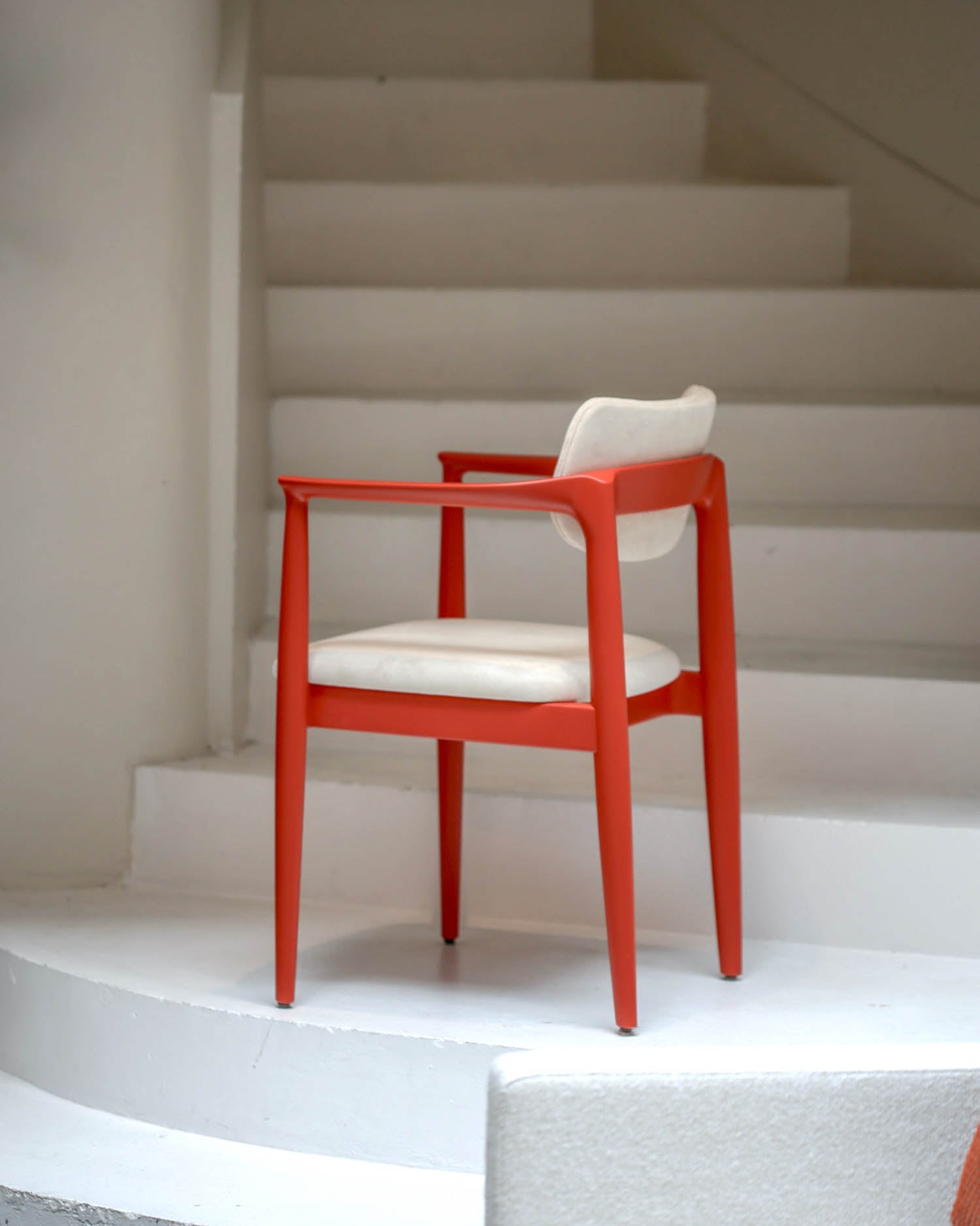 white chair with red arms