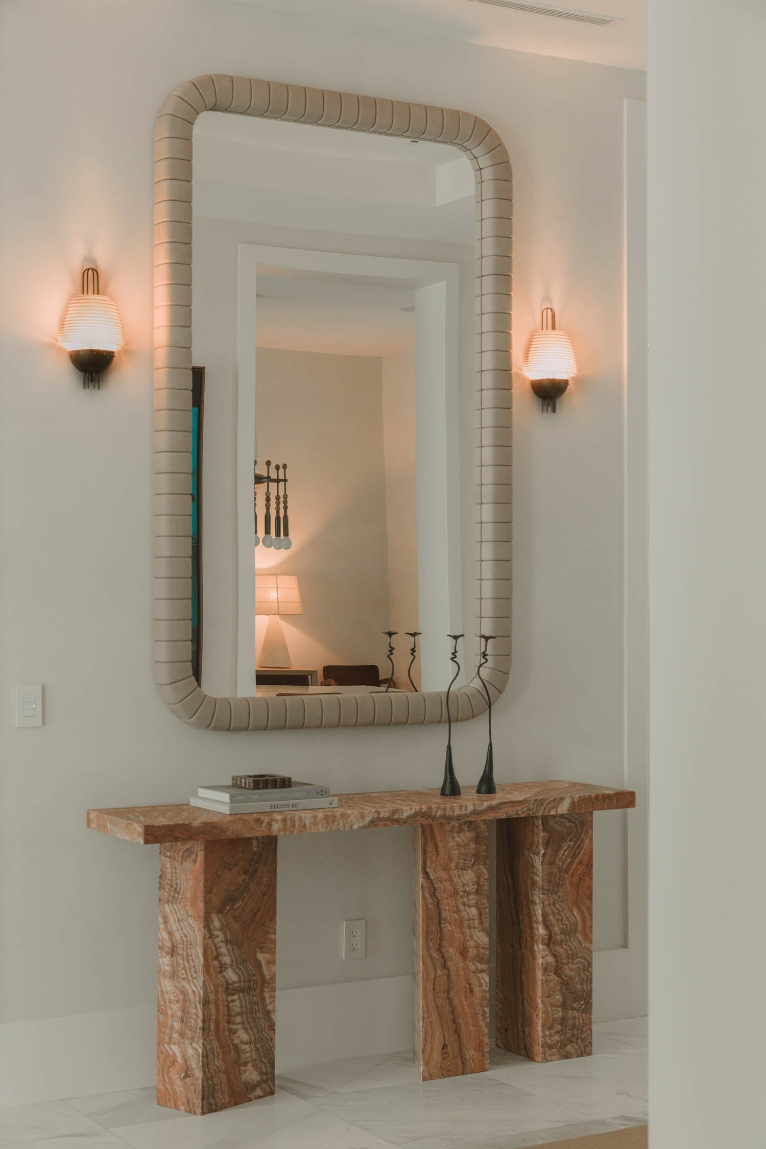 entry area with marbled side console and detailed mirror