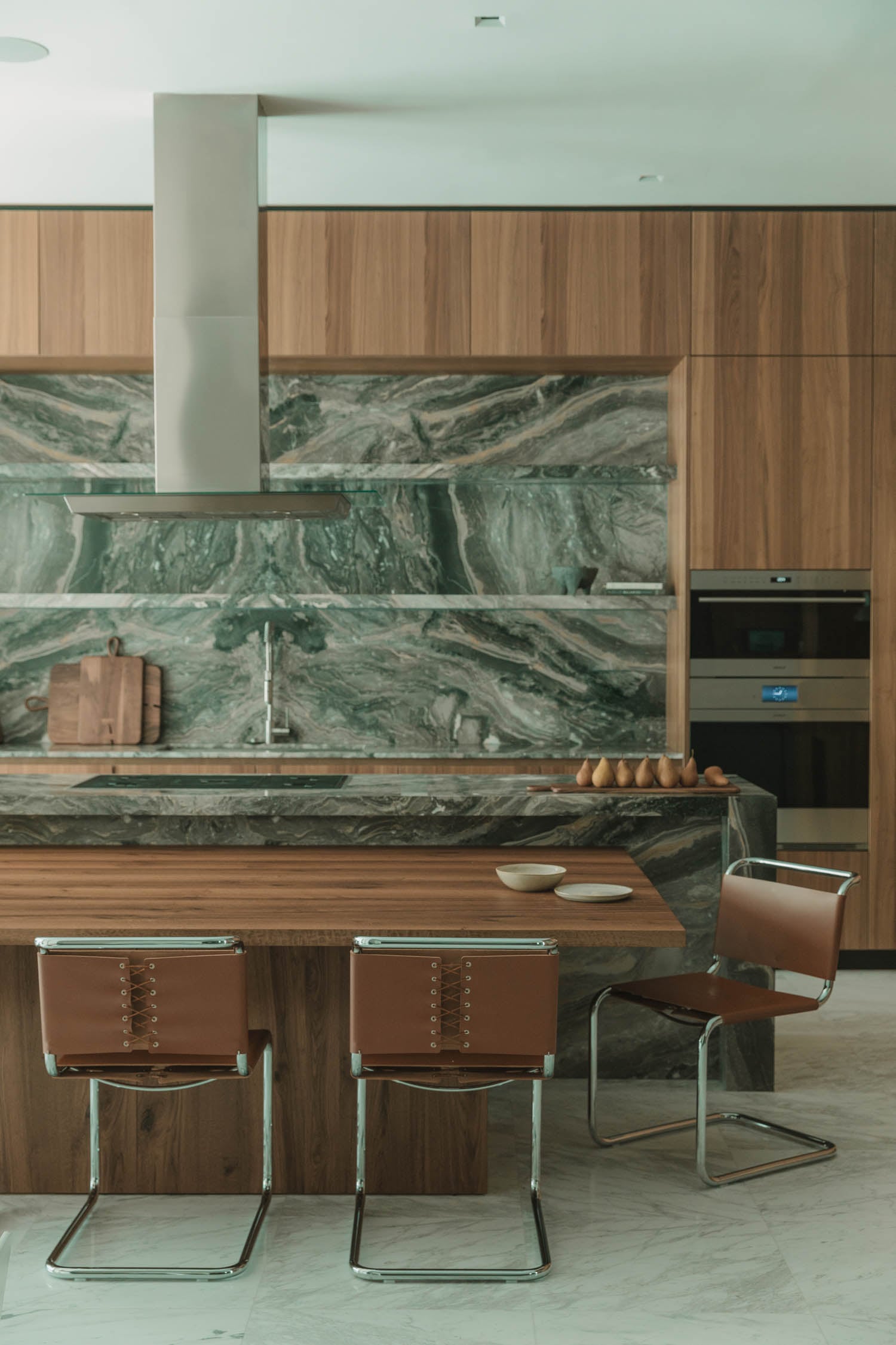 kitchen with marbled backdrop and wooden table