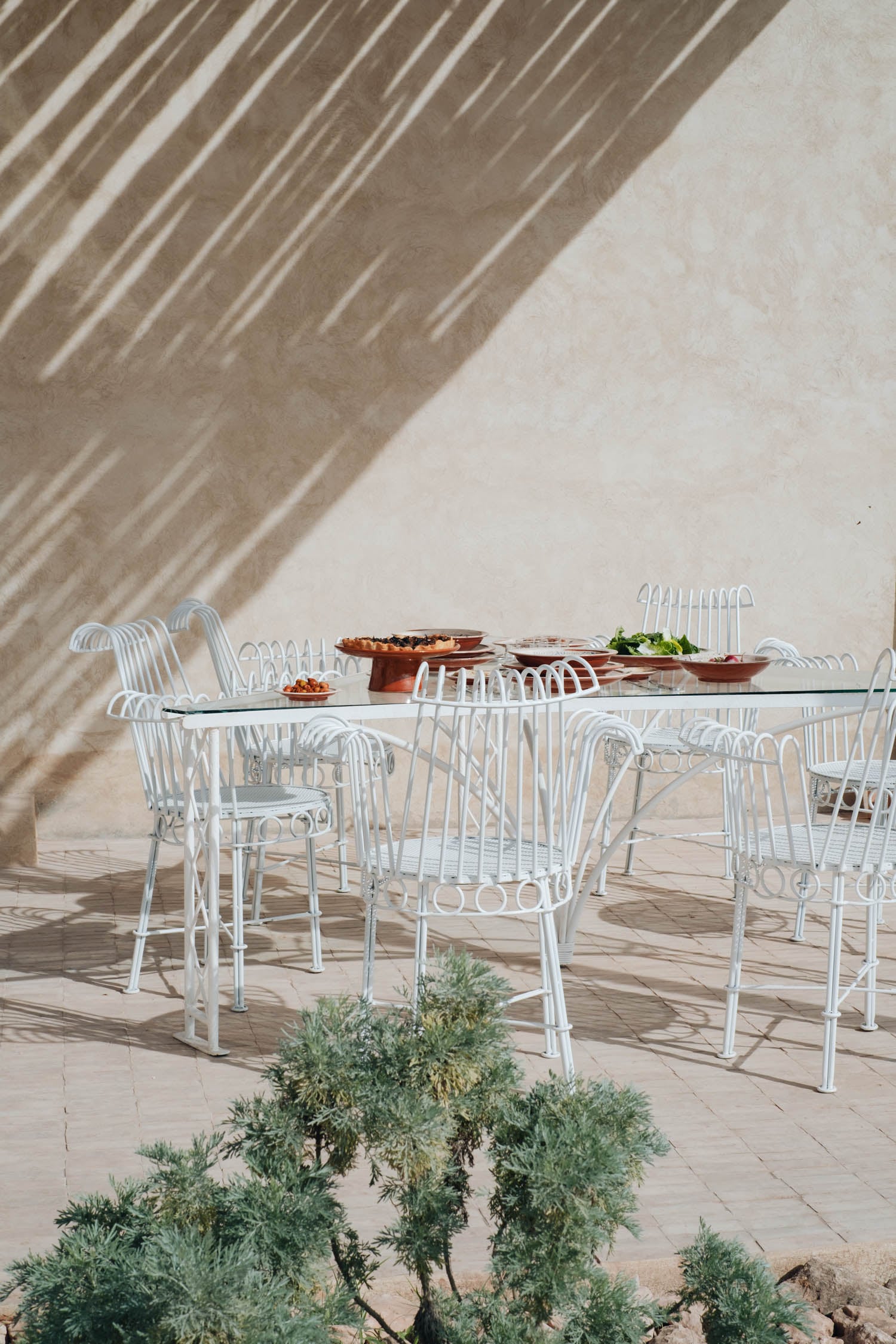 the terrace area with white table and chairs
