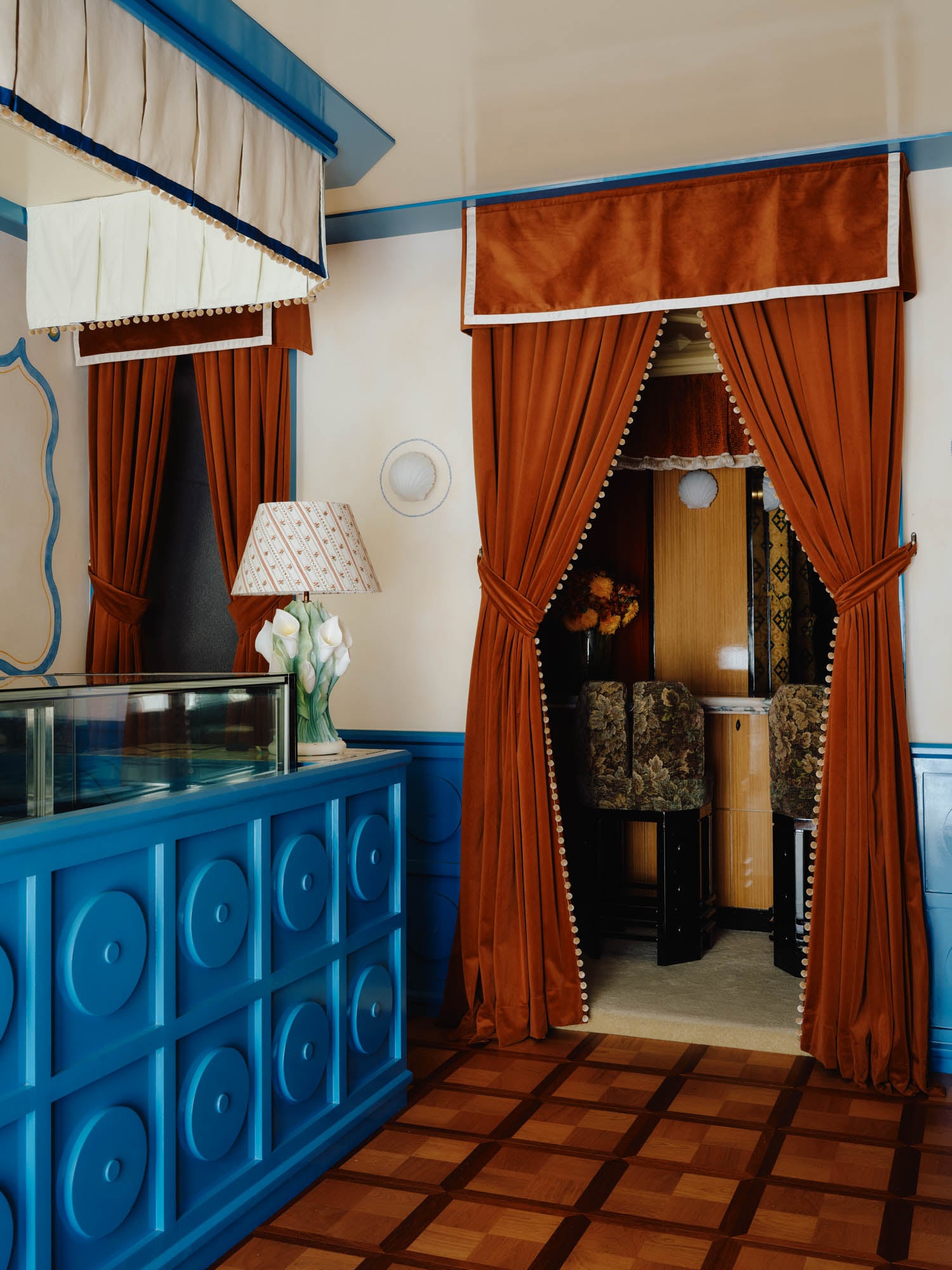 corner of room with red curtain and flooring