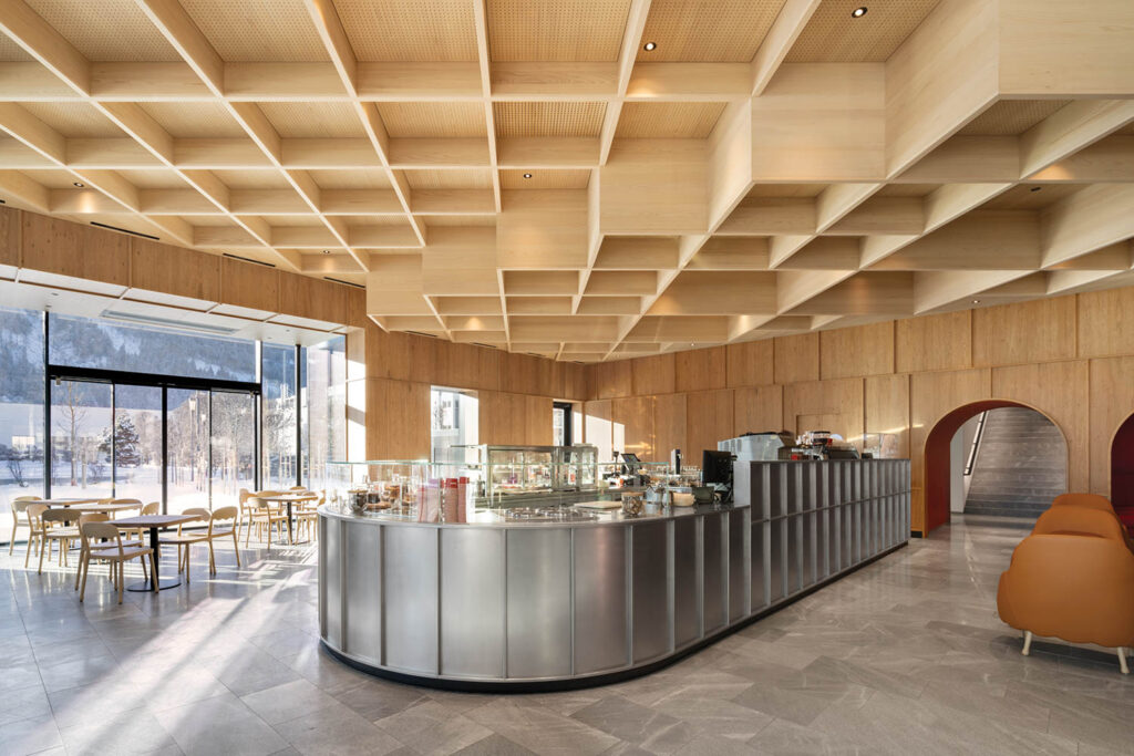 A restaurant with a large counter and a bar.