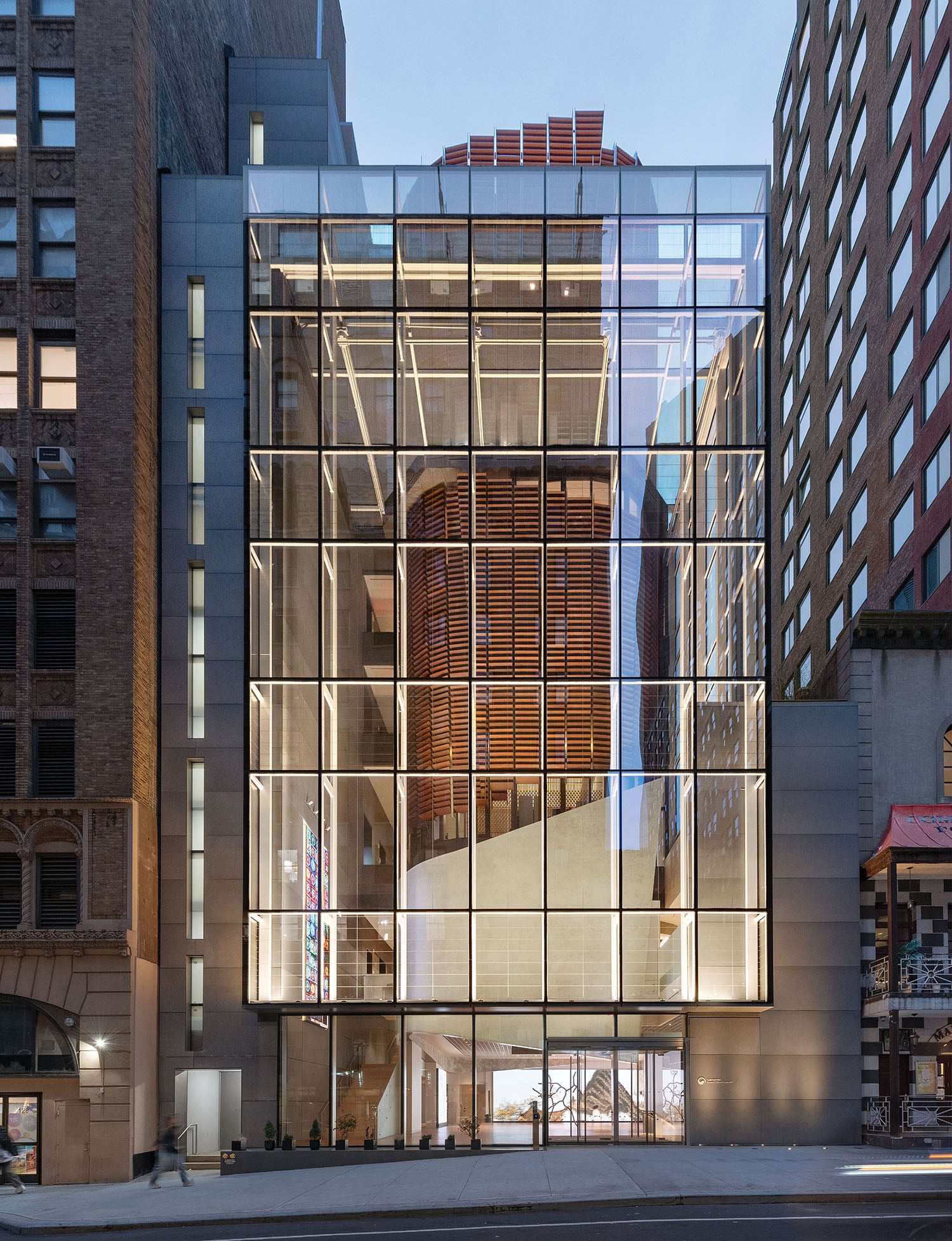 A building with a glass facade on the side.