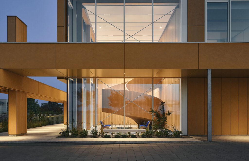 a large building with a glass window and a bench